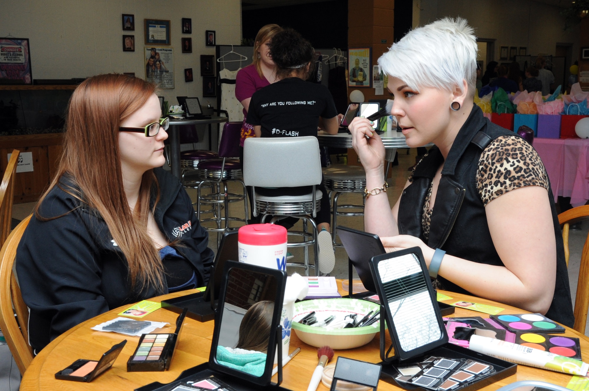 Volunteer Sam Dames (right) discusses the finer points of makeup with Jessica Hatcher at the 319th Force Support Squadron Prom Prep Academy event at the Youth Center on Grand Forks Air Force Base, N.D., March 8, 2014. The event provided high school students the opportunity to learn about makeup and hairstyles, as well as pick out a donated prom dress. (U.S. Air Force photo/Staff Sgt. David Dobrydney)