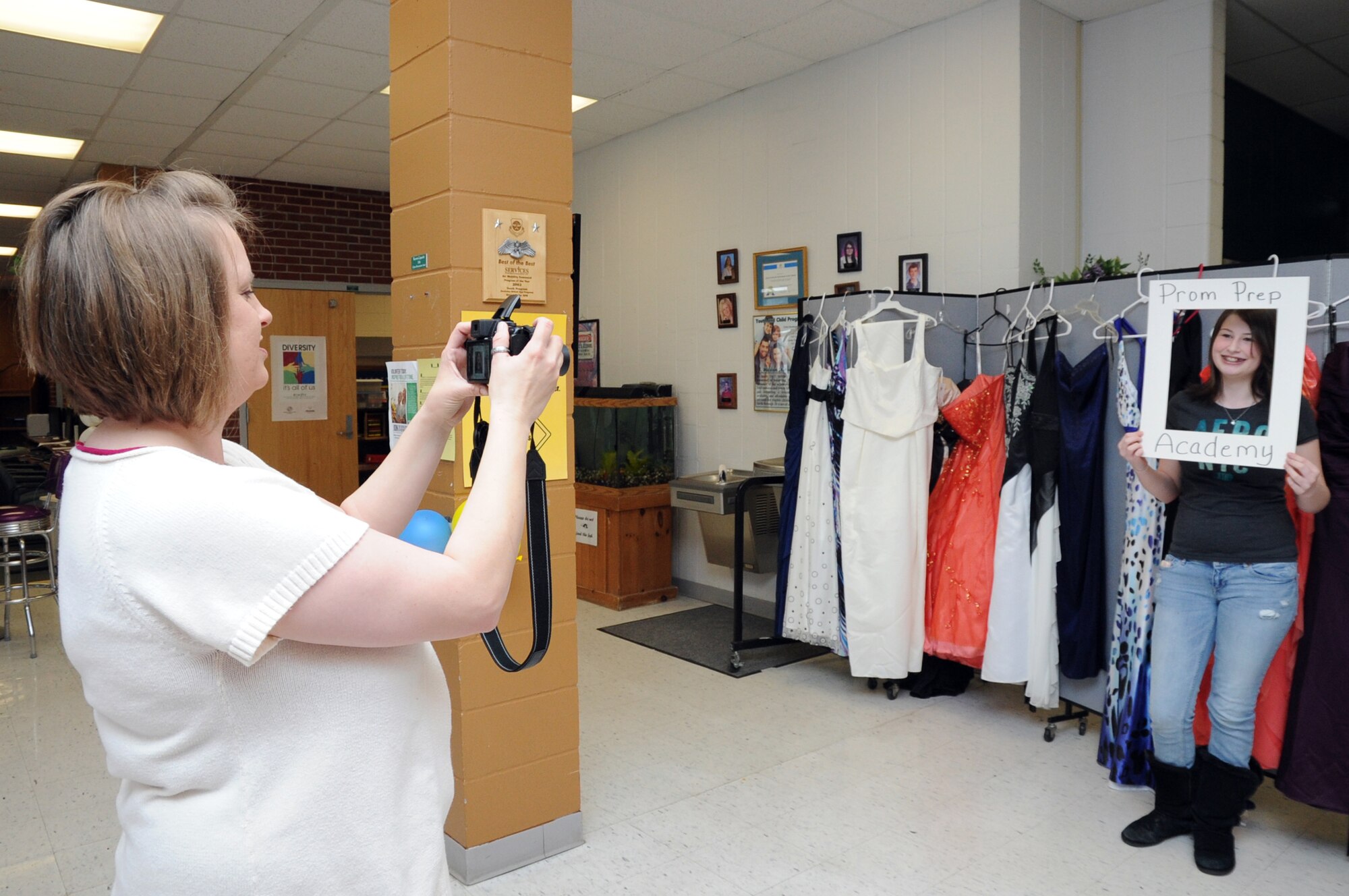 Toria Knox poses for a 'before' photo taken by Heather Holmes during the 319th Force Support Squadron Prom Prep Academy event at the Youth Center on Grand Forks Air Force Base, N.D., March 8, 2014. The event was designed to help teens get ready for school proms with tips on makeup, hairstyles and picking out a dress. (U.S. Air Force photo/Staff Sgt. David Dobrydney)