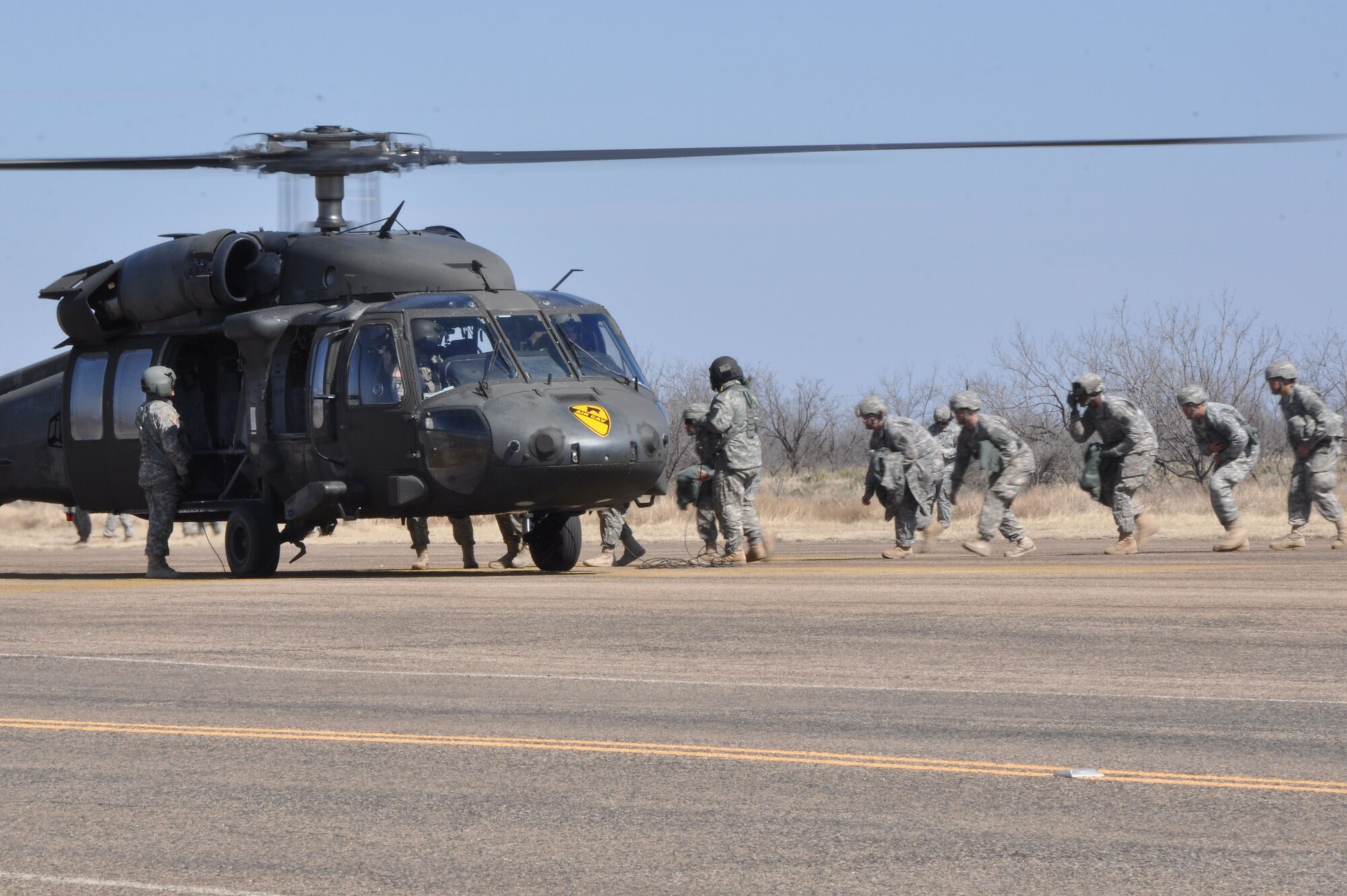 GOODFELLOW AIR FORCE BASE, Texas – Soldiers from the 15th Military Intelligence Aerial Exploitation Battalion board the UH-60 Blackhawk helicopter Feb. 27 to return to Fort Hood, Texas, after their three-day exercise here. For part of their training, they teamed with Goodfellow soldiers from the 344th Military Intelligence Battalion to run paintball battle drills on the combat simulation course here. (U.S. Air Force photo/ Airman 1st Class Breonna Veal) 