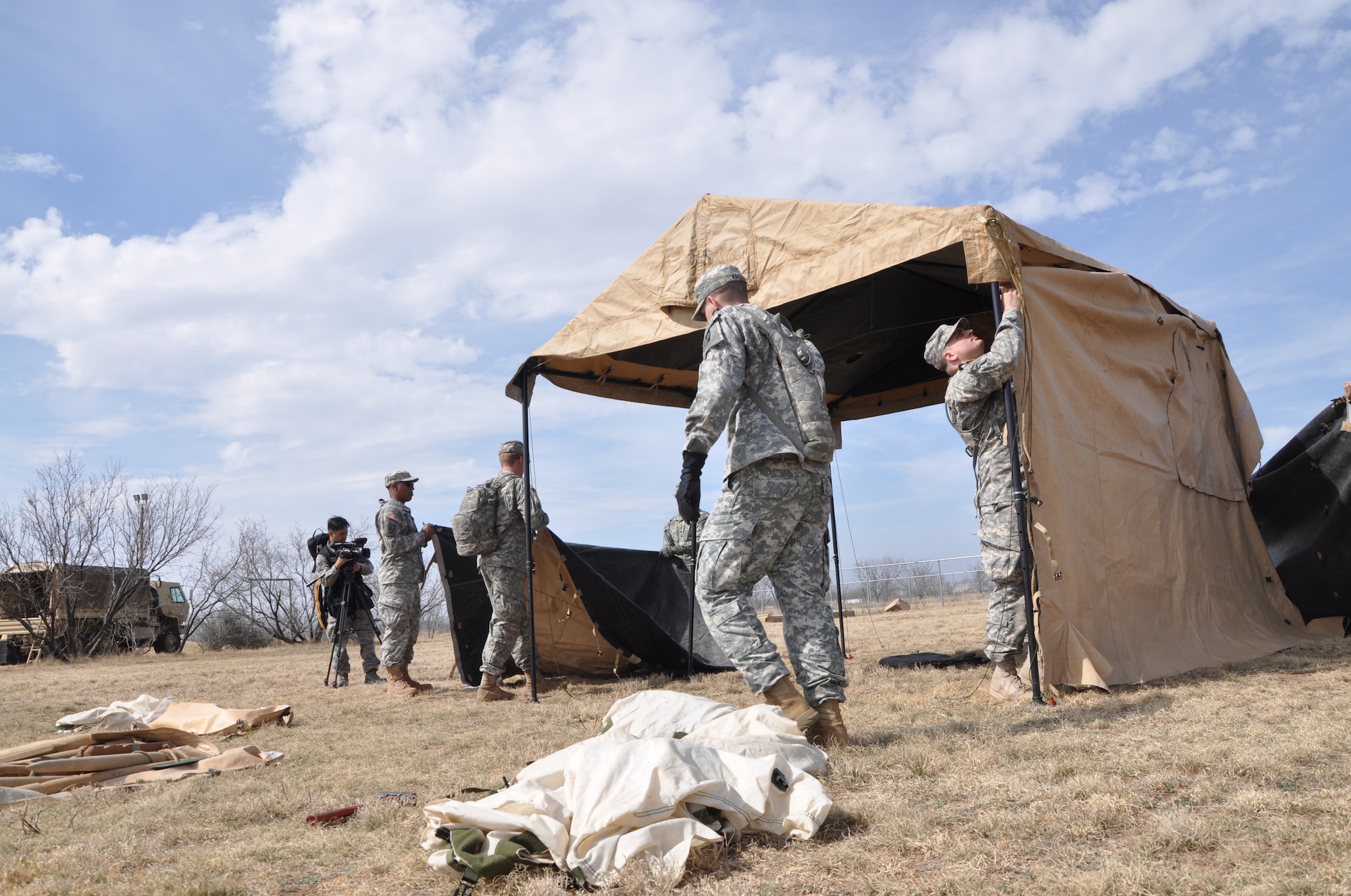 GOODFELLOW AIR FORCE BASE, Texas -- Soldiers from the 15th Military Intelligence Aerial Exploitation Battalion set up the command tent during their exercise here Feb. 24. The 15 MI BN (AE) came to Goodfellow Air Force Base to conduct a field training exercise to test intelligence systems and maintain their Army Warrior Tasks with the 344th Military Intelligence Battalion. (U.S. Air Force photo/ Airman 1st Class Breonna Veal)