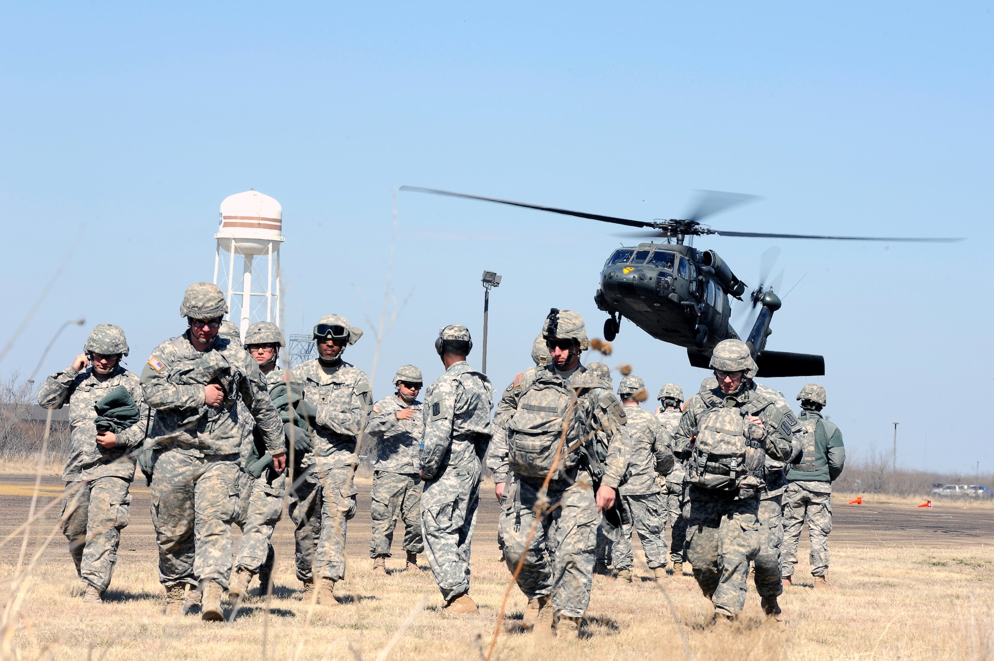 GOODFELLOW AIR FORCE BASE, Texas –Soldiers from the 15th Military Intelligence Aerial Exploitation Battalion prepare to return to Fort Hood, Texas, on a UH-60 Blackhawk helicopter Feb. 27.  The 15th MI BN (AE) came to Goodfellow to conduct a field training exercise, which tested intelligence systems and the proficiency of their Army Warrior Tasks. (U.S. Air Force photo/ Staff Sgt. Austin Knox)