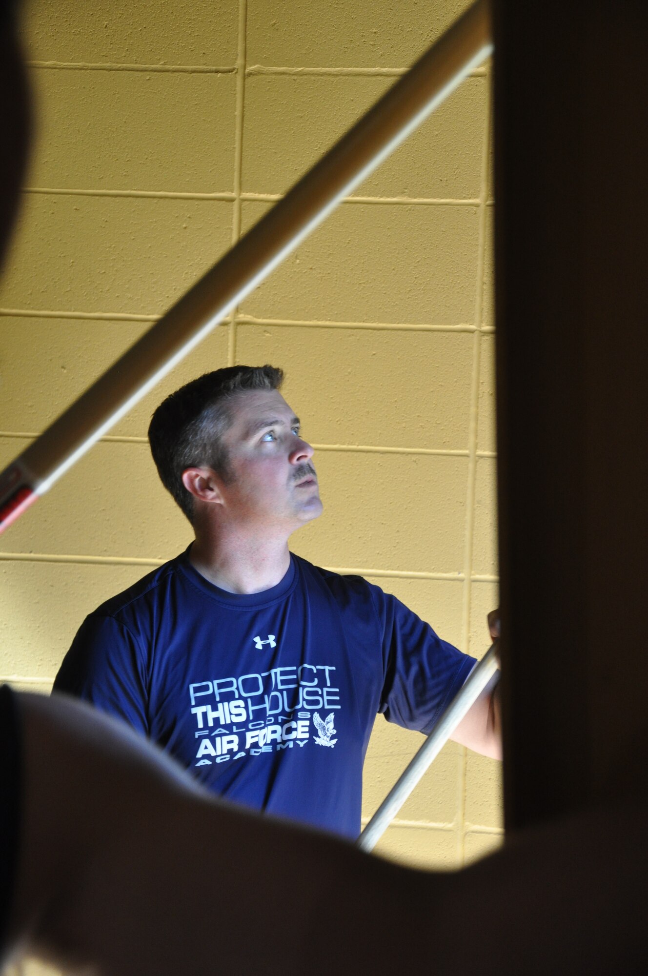 Col. David E. Graff, 325th Fighter Wing commander, helps the 325th Propulsion Flight paint the gym of the Boys and Girl Club Chapman Center. Team Tyndall Airmen partnered with more than 40 non-profit organizations as part of their quarterly Comprehensive Airmen Fitness Day March 10. The day was focused on giving back to Bay County with volunteer service projects. (Air Force Photo by Herm Bell)  