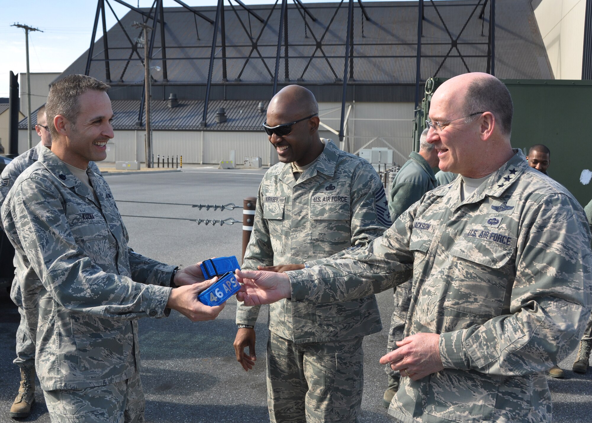 Lt. Col. Gregory Kuzma, 46th Aerial Port Squadron commander, hands Lt. Gen. James F. Jackson, Air Force Reserve Command commander, a customized safety reflective belt during a tour March 1, 2014, of the largest aerial port in the Department of Defense, on Dover Air Force Base, Del. Jackson and Chief Master Sgt. Cameron B. Kirksey, AFRC command chief, visited various 512th Airlift Wing units during the day and attended the wing's annual awards banquet that evening. (U.S. Air Force photo/Senior Airman Erika Brooke) 