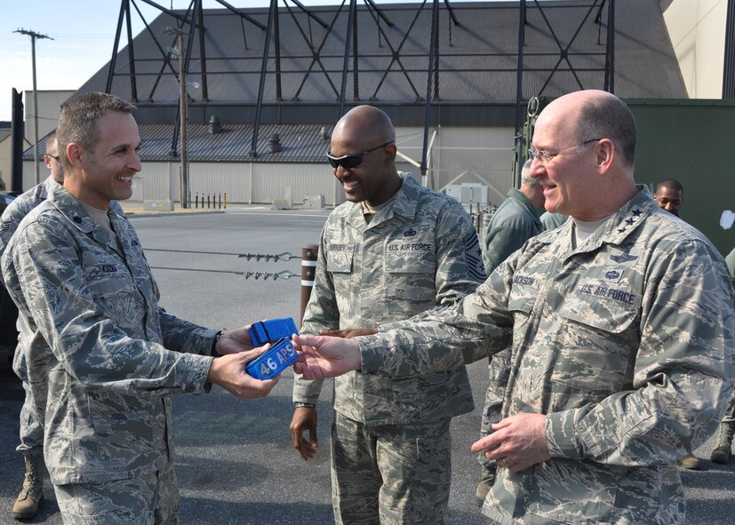 Lt. Col. Gregory Kuzma, 46th Aerial Port Squadron commander, hands Lt. Gen. James F. Jackson, Air Force Reserve Command commander, a customized safety reflective belt during a tour March 1, 2014, of the largest aerial port in the Department of Defense, on Dover Air Force Base, Del. Jackson and Chief Master Sgt. Cameron B. Kirksey, AFRC command chief, visited various 512th Airlift Wing units during the day and attended the wing's annual awards banquet that evening. (U.S. Air Force photo/Senior Airman Erika Brooke) 