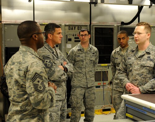 U.S. Air Force Chief Master Sgt. Richard Parsons, Air Combat Command command chief, tours the avionics flight of the 7th Maintenance Group March 5, 2014, at Dyess Air Force Base, Texas. Senior Airman Pedro Rodas, right, 7th MXG avionics technician, guided Parsons through the avionics building and explained their mission and the functions of different systems in their shop. (U.S. Air Force photo by Airman 1st Class Alexander Guerrero/Released)