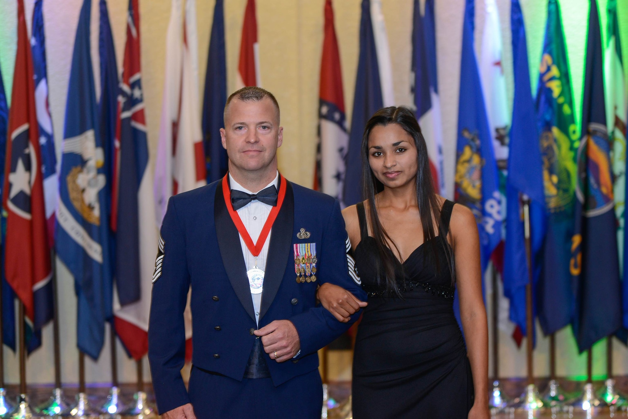 Chief Master Sgt. Derek Fromenthal, 81st Training Support Squadron, and his wife, take a photo during the Chiefs Recognition Ceremony Feb. 28, 2014, at the Bay Breeze Event Center, Keesler Air Force Base, Miss.  Keesler had four Airmen that were honored for attaining the rank of chief master sergeant. (Courtesy photo by Airman 1st Class Andrew Achong)