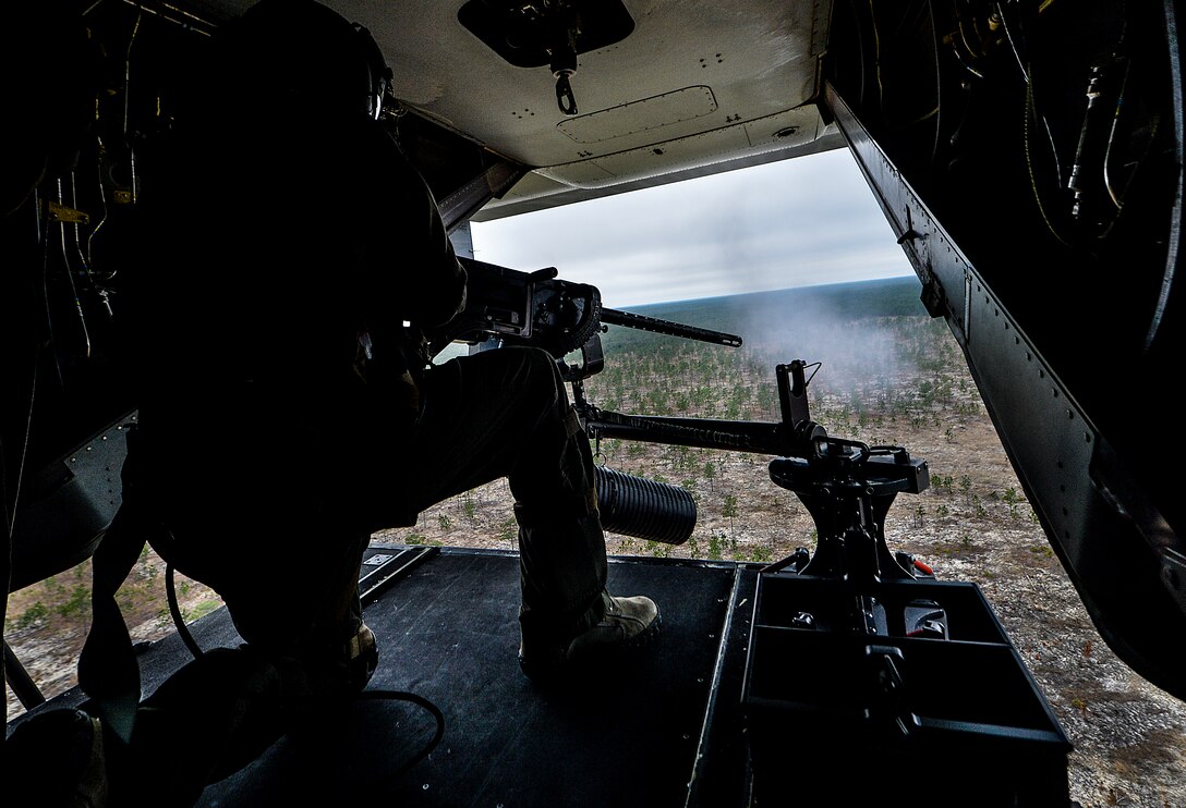 Tech. Sgt. Edilberto Malave, 8th Special Operations Squadron flight engineer, shoots a .50 caliber machine gun mounted to the ramp of a CV-22 Osprey near Hurlburt Field, Fla., March 6, 2014. This versatile, self-deployable aircraft offers increased speed and range over other rotary-wing aircraft, enabling Air Force Special Operations Command aircrews to execute long-range special operations missions.