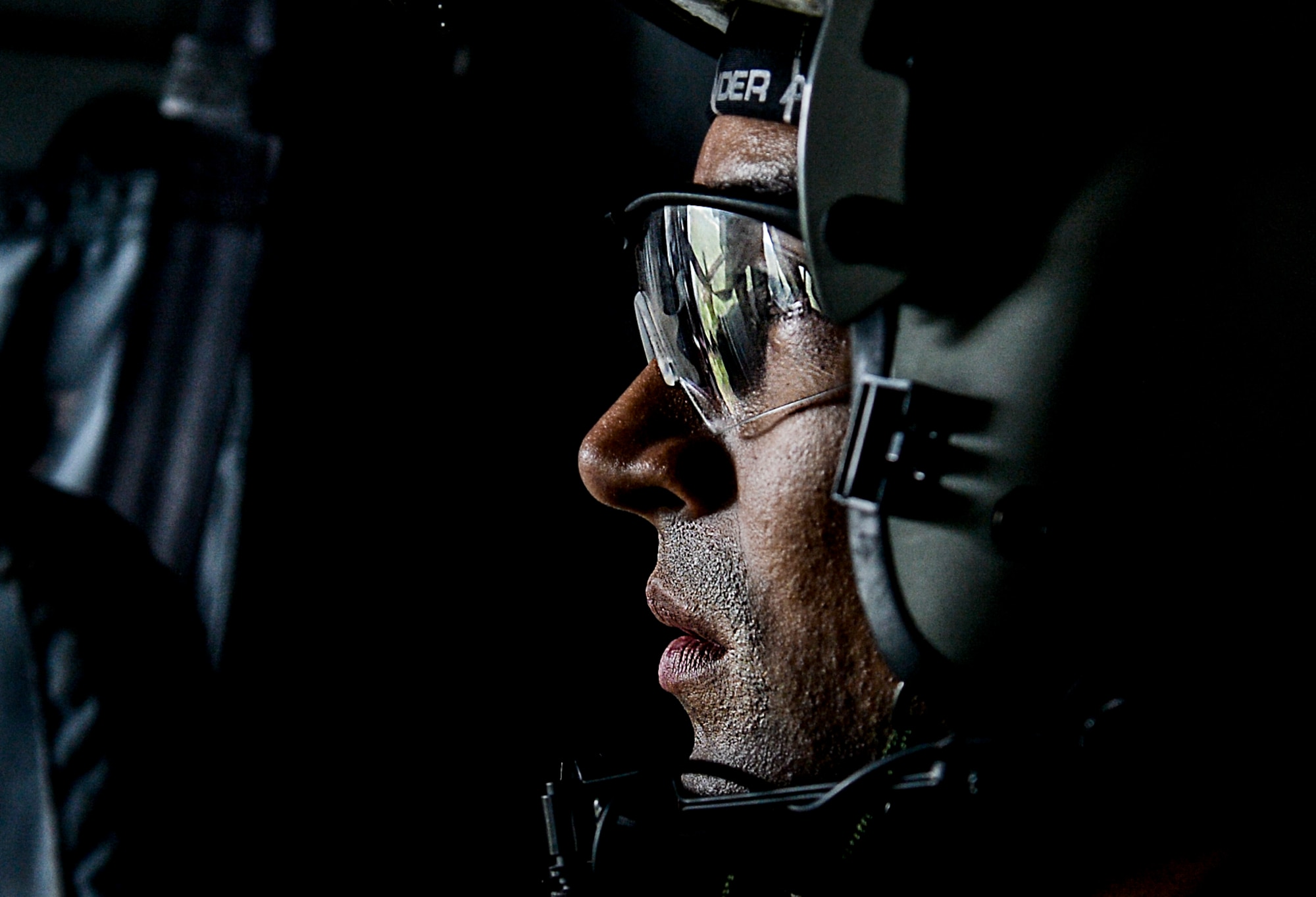 Tech. Sgt. Edilberto Malave, 8th Special Operations Squadron flight engineer, looks on as another flight engineer shoots the .50 caliber machine gun mounted to the ramp of a CV-22 Osprey near Hurlburt Field, Fla., March 6, 2014. The Osprey’s mission is to conduct long-range infiltration, exfiltration and resupply missions for special operations forces. (U.S. Air Force photo/Senior Airman Christopher Callaway) 