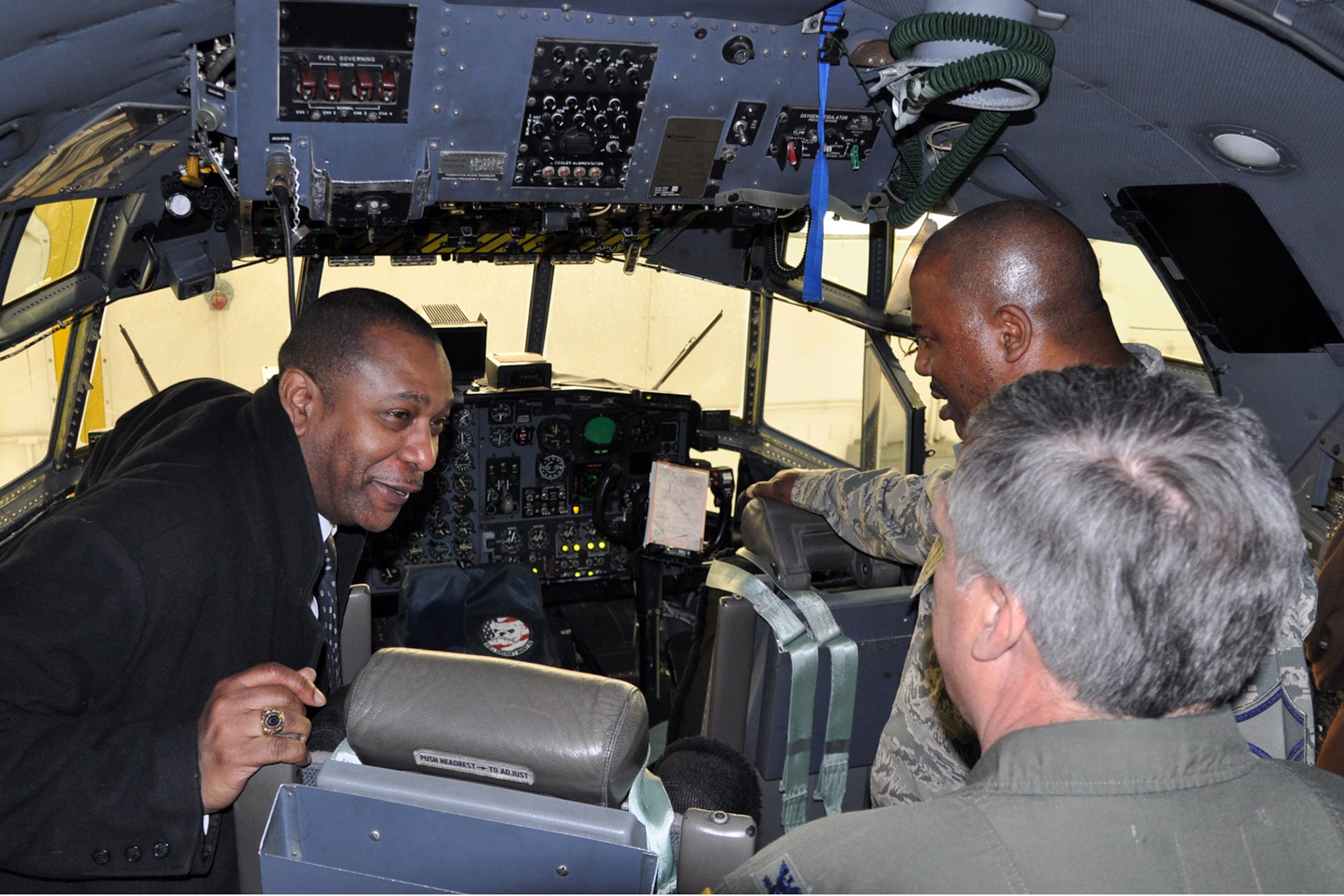 YOUNGSTOWN AIR RESERVE STATION, Ohio – Following a tour of the 910th Airlift Wing’s 76th Aerial Port Squadron and a windshield tour of the installation, the mayor’s tour continued to one of the installation’s maintenance hangars, where he had the opportunity to get an up close and personal view of one of the wing’s assigned cargo aircraft. Air Force Reserve Col. Bill Phillips (center), commander of the 910th Operations Group and Master Sgt. Less Parkey (right), an crew chief assigned to the 910th Aircraft Maintenance Squadron, both based here, talks with Mayor Doug Franklin (left), of the nearby City of warren, about aircraft capabilities on the flight deck of a C-130 Hercules cargo aircraft in a hangar here, March 7, 2014. The mayor visited YARS to learn more about the wing’s capabilities and the installation’s features firsthand as well as meet some of the Citizen Airmen assigned here.