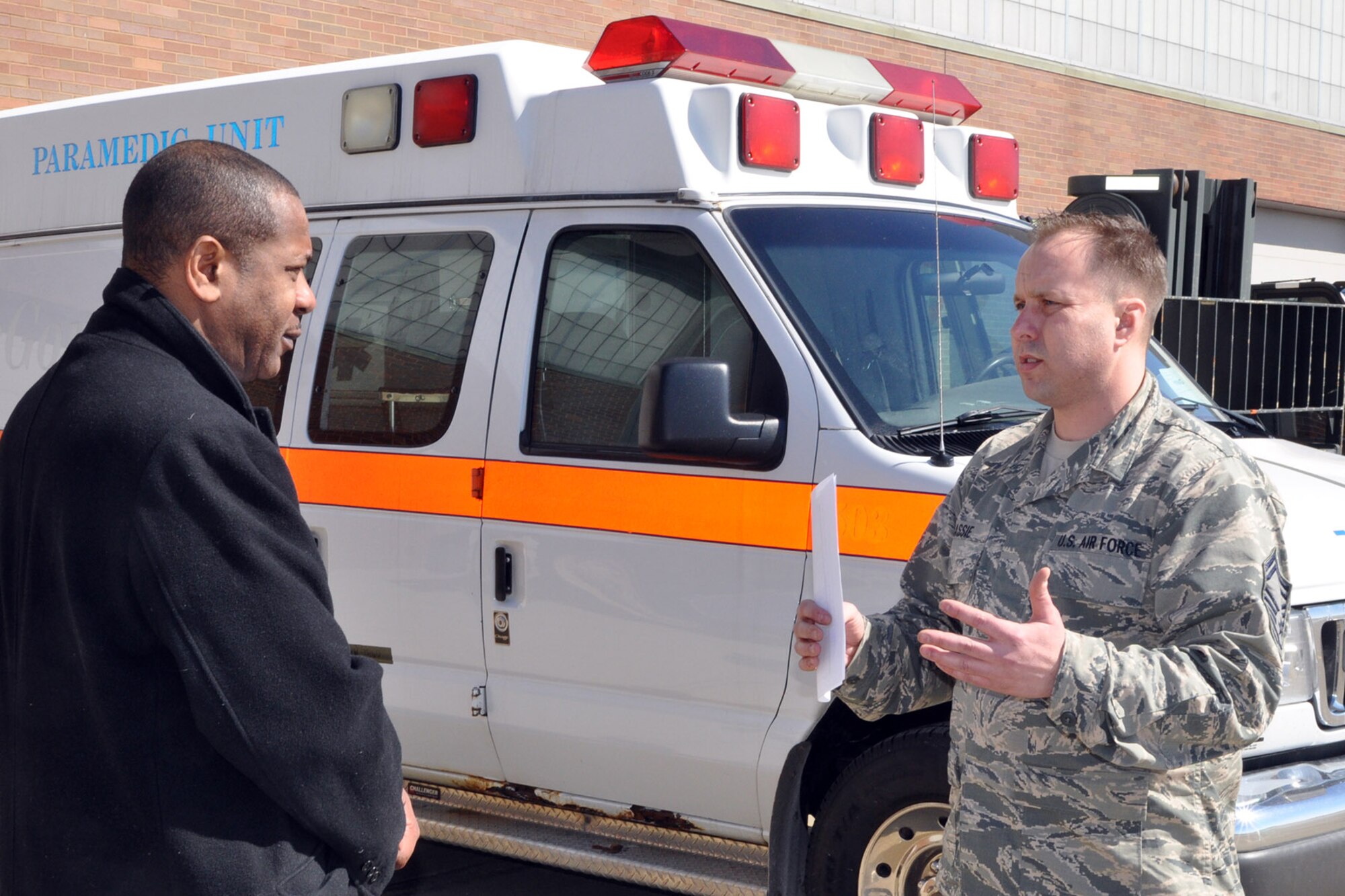 YOUNGSTOWN AIR RESERVE STATION, Ohio – The mayor’s tour of the 910th Airlift Wing’s 76th Aerial Port Squadron continued with a visit to the unit’s ramp operations. Air Force Reserve Senior Master Sgt. Kevin Massie (right), 76th APS superintendent, talks with Mayor Doug Franklin (left), of the nearby City of Warren, on the flightline here, March 7, 2014, about the unit’s efforts to prepare the ambulance sitting in the background for loading aboard an inbound cargo aircraft. The ambulance was being flown from YARS as part of the Denton program, a U.S. government program allowing charitable organizations to use existing military airlift missions to transport humanitarian cargo to locations around the world. The mayor visited YARS to learn more about the wing’s capabilities and the installation’s features firsthand as well as meet some of the Citizen Airmen assigned here.