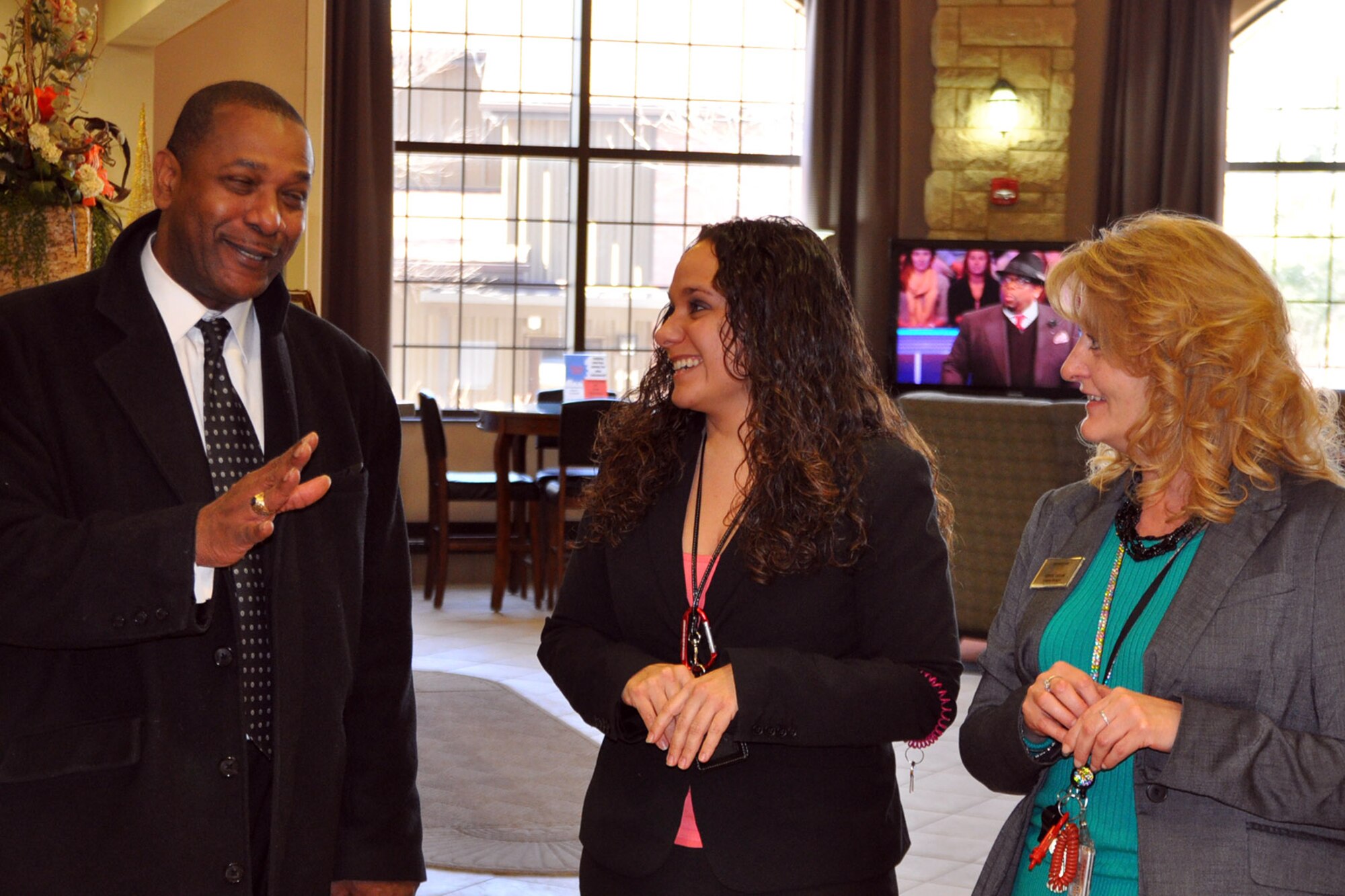 YOUNGSTOWN AIR RESERVE STATION, Ohio – Mayor Doug Franklin, of the nearby city of Warren, shares a laugh during a talk about facilities amenities with Air Force Reserve 910th Guest Services Manager Jenn Clutter (center) and 910th Lodging Manager Cheryl Taylor in the Eagle’s Nest Lodge’s lobby here, March 7, 2014. Following a group meal at the adjacent YARS Community Activity Center, Mayor Franklin continued his installation visit with a tour of the 123-room lodging facility. The mayor visited YARS to learn more about the wing’s capabilities and the installation’s features firsthand as well as meet some of the Citizen Airmen assigned here.