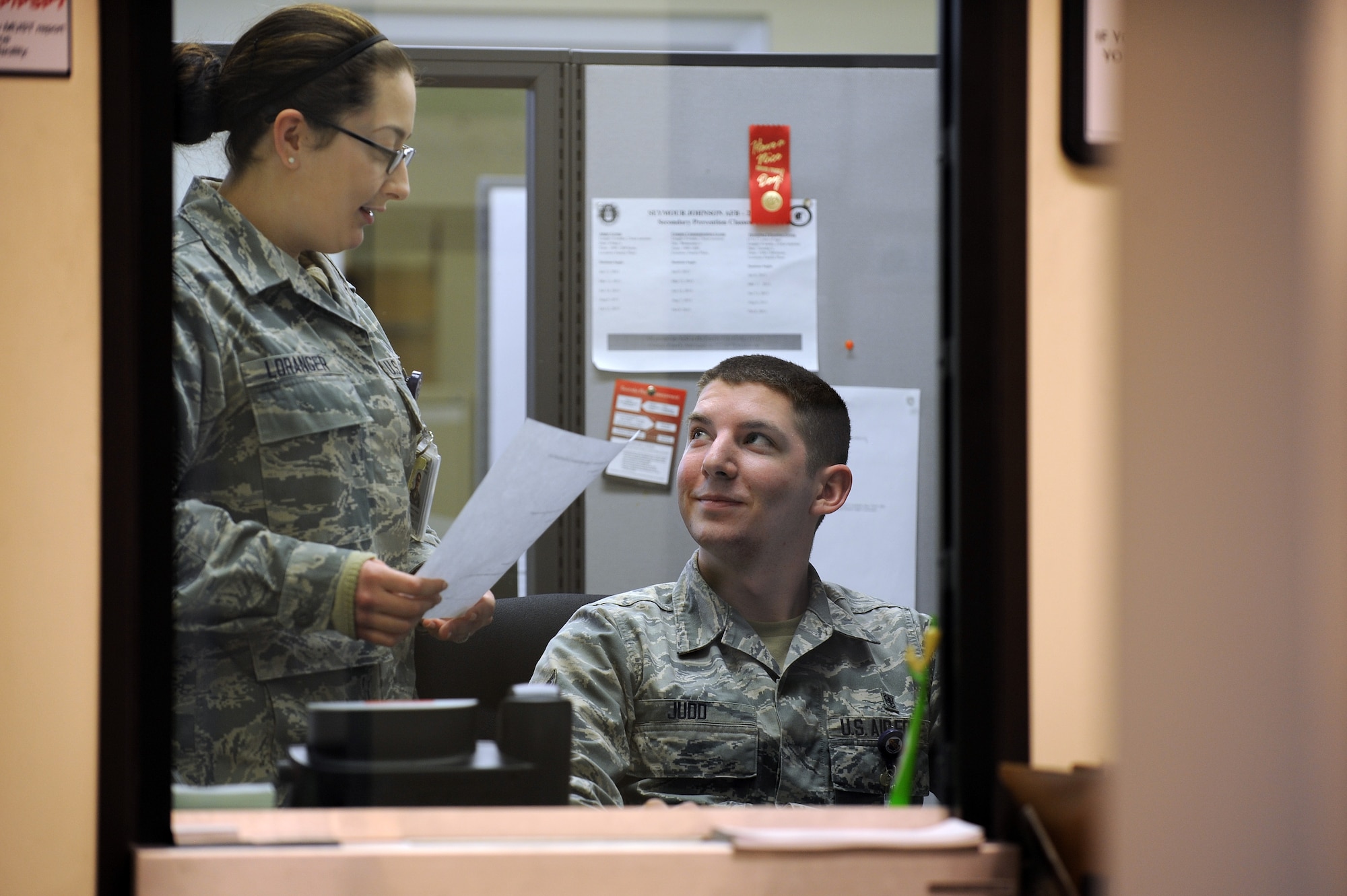 From left, Airmen 1st Class Kathryn Loranger and Kiernan Judd, 4th Medical Operations Squadron mental health technicians, talk in their office, March 7, 2014, at Seymour Johnson Air Force Base, N.C. The newlyweds have been married less than a year and said they are being proactive to set their marriage up for success. (U.S. Air Force photo/Airman 1st Class Aaron J. Jenne)