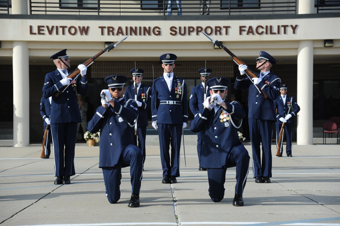 The U.S. Air Force Honor Guard Drill Team performs a new routine on the drill pad behind the Levitow Training Support Facility March 7, 2014, at Keesler Air Force Base, Miss.  The routine was developed here during the past month and will be used for the next year. (U.S. Air Force photo by Kemberly Groue)