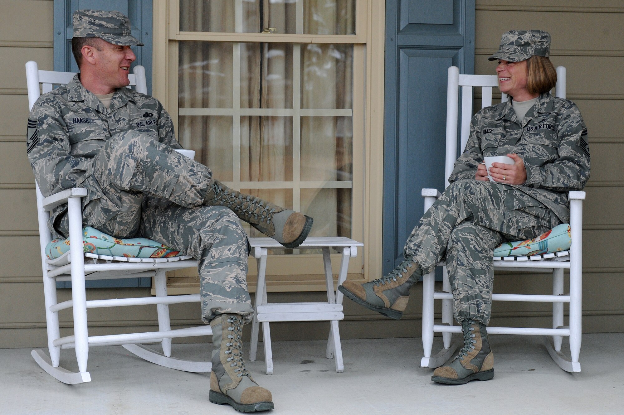 From left, Chief Master Sgt. Robert Haase, 4th Force Support Squadron superintendent, and his wife Senior Master Sgt. Melissa Haase, 4th Contracting Squadron superintendent, relax on the porch of their home March 6, 2014, in Goldsboro, N.C. The Haase’s have been married 14 years and have seen deployments, special duty assignments and permanent changes of station. Despite the challenges they have faced, they have found a way to make their military marriage successful. (U.S. Air Force photo/Airman 1st Class Aaron J. Jenne)