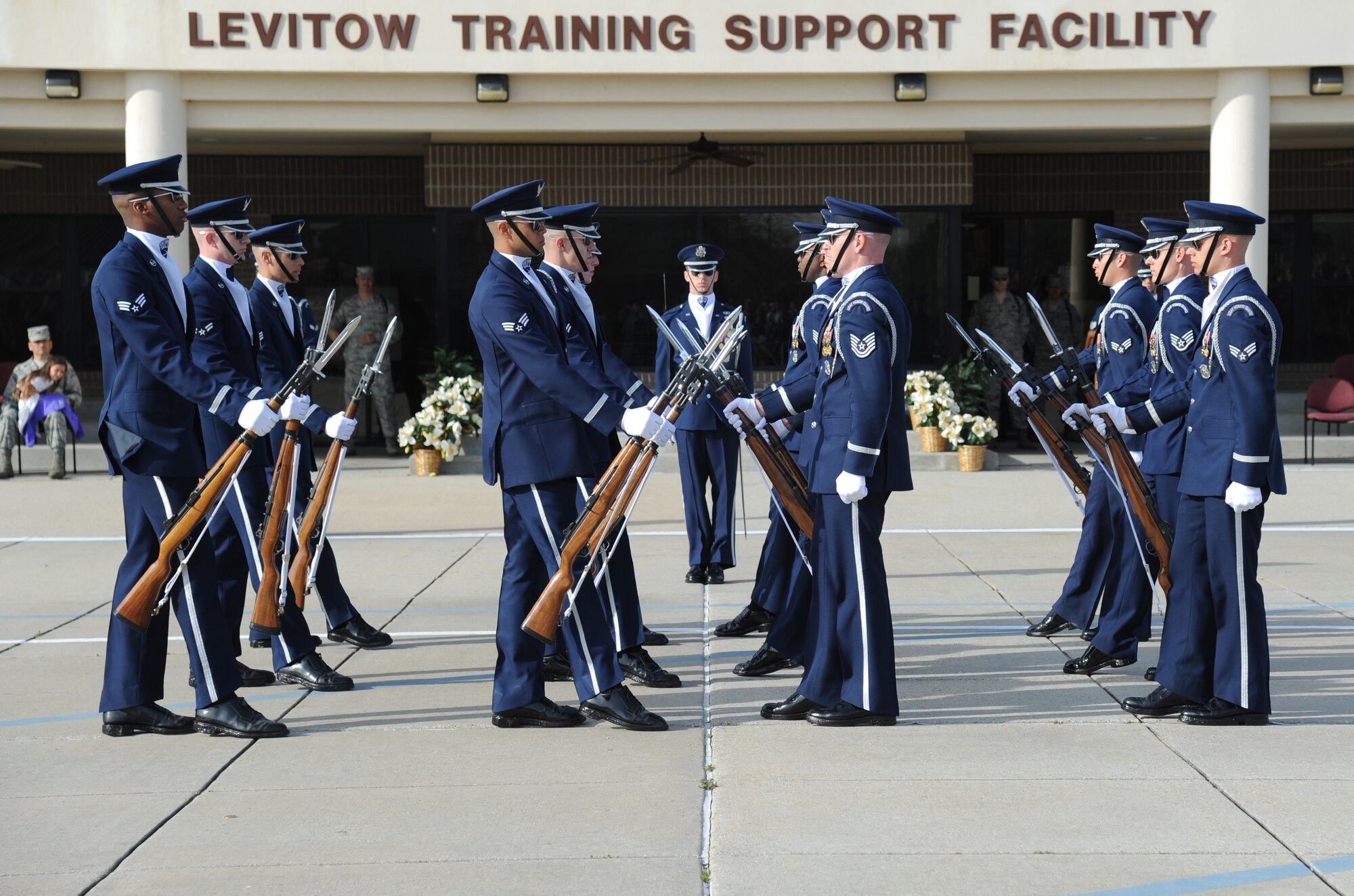The U.S. Air Force Honor Guard Drill Team performs a new routine on the drill pad behind the Levitow Training Support Facility March 7, 2014, at Keesler Air Force Base, Miss.  The routine was developed here during the past month and will be used for the next year. (U.S. Air Force photo by Kemberly Groue)