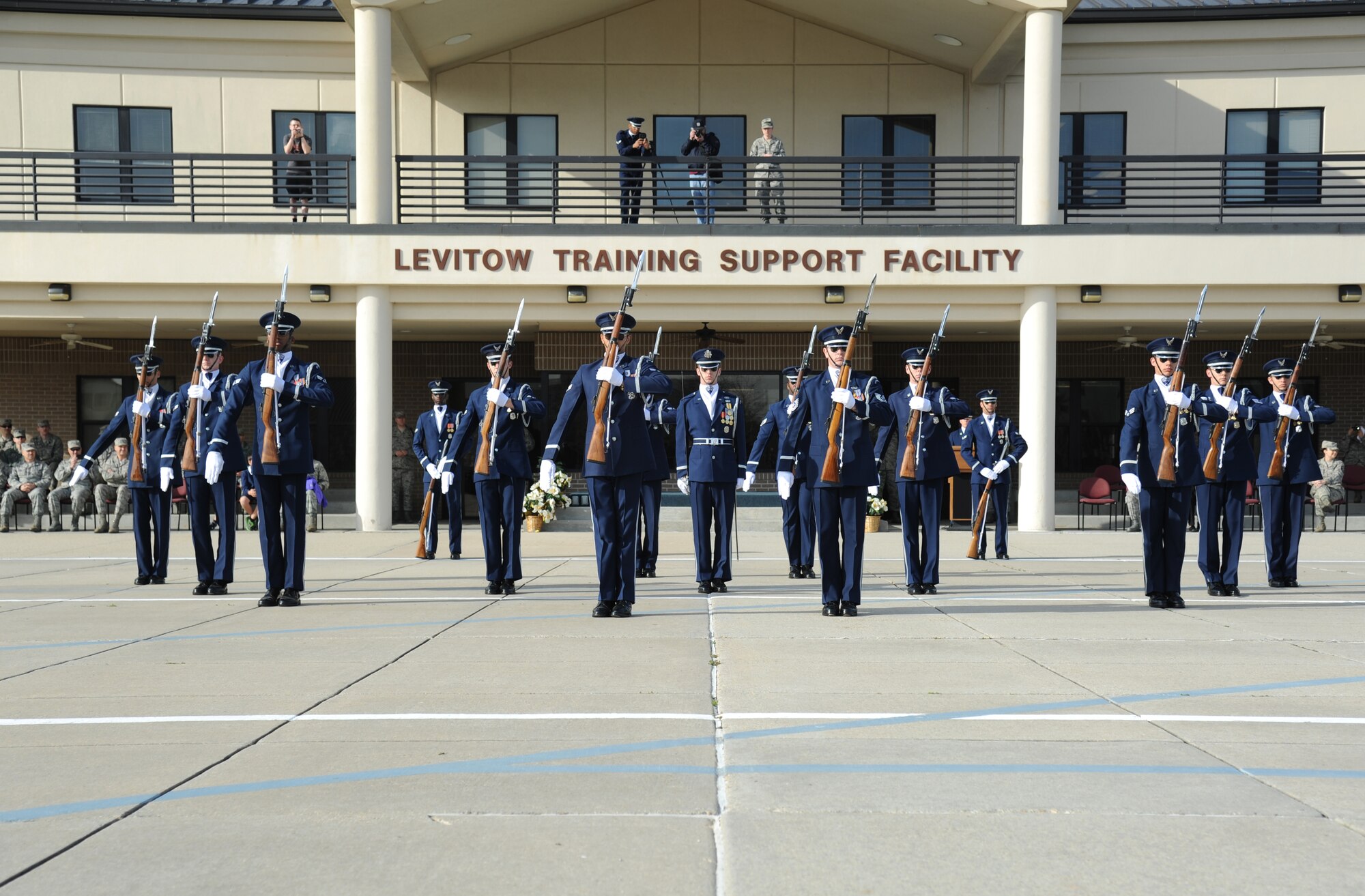 The U.S. Air Force Honor Guard Drill Team performs a new routine on the drill pad behind the Levitow Training Support Facility March 7, 2014, at Keesler Air Force Base, Miss.  The routine was developed here during the past month and will be used for the next year. (U.S. Air Force photo by Kemberly Groue)