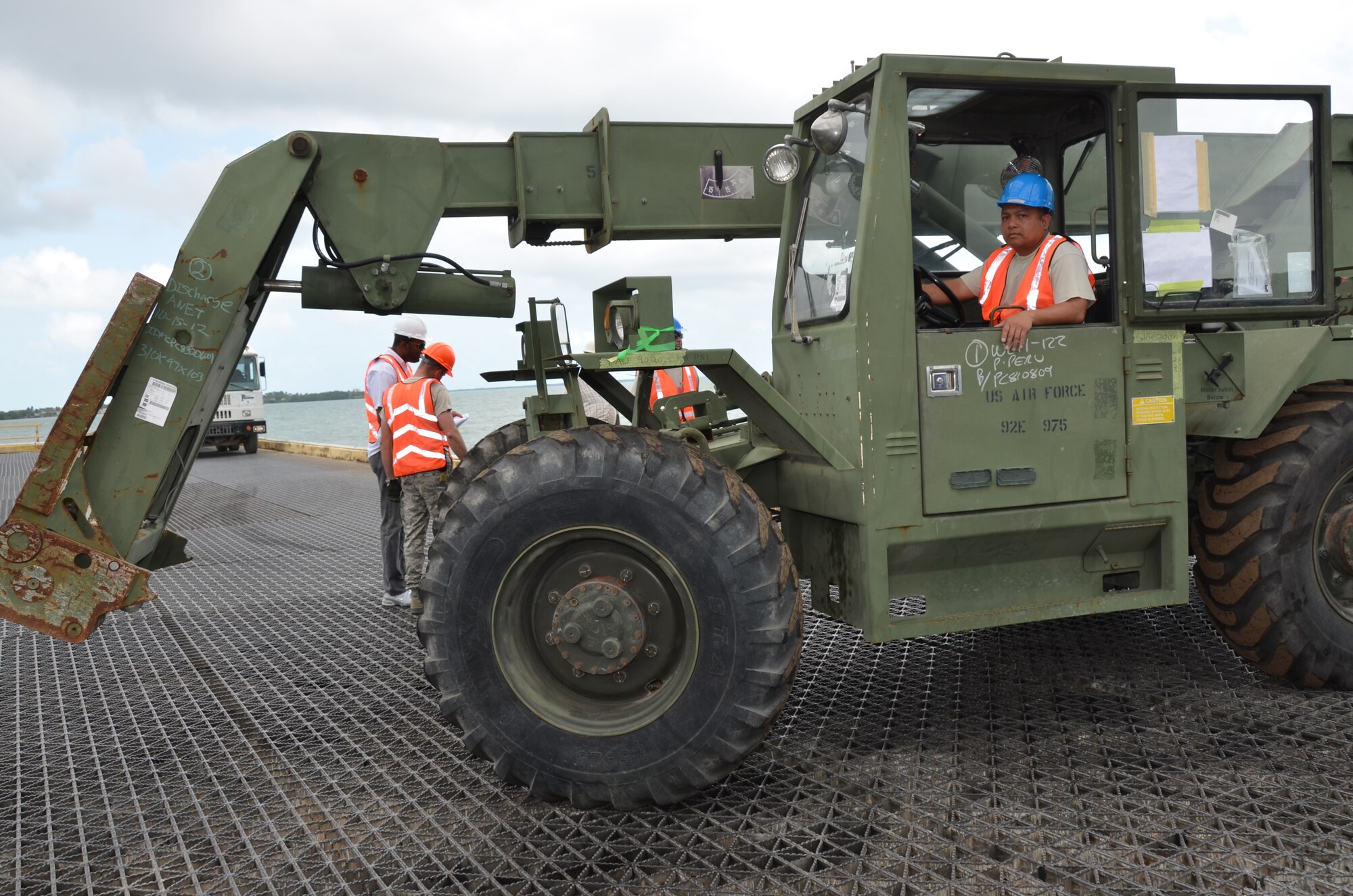 Master Sgt. Enrique Naranjo, New Horizons logistics superintendent, drives a piece of engineering equipment off of the barge, March 8. Belizeans will begin noticing an influx of U.S. military equipment traveling from the Port of Belize to various locations throughout the country in support of New Horizons. (USAF photo by Master Sgt. Kelly Ogden/Released)