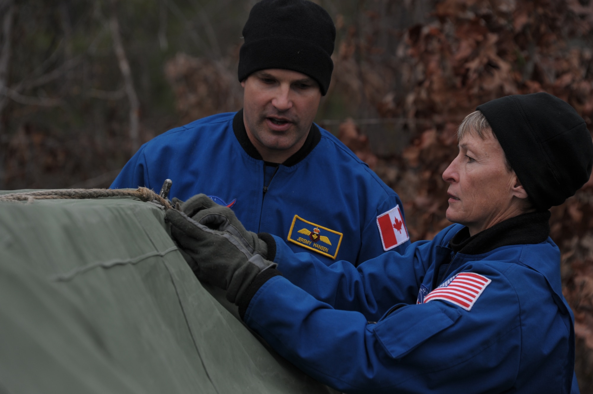 Peggy Whitson, training lead for astronaut expeditionary skills at the NASA Johnson Space Center in Houston, and Maj. Jeremy Hansen, Royal Canadian air force astronaut, assemble a tent at the vigilant warrior training range near Maxwell Air Force Base, March 4th. The training provided a survival scenario where the group of six astronauts had to build shelter and survive the night while dealing with exercise inputs from the Academy of Military sciences administrators. (U.S. Air Force Photo by Staff Sgt. Gregory Brook)