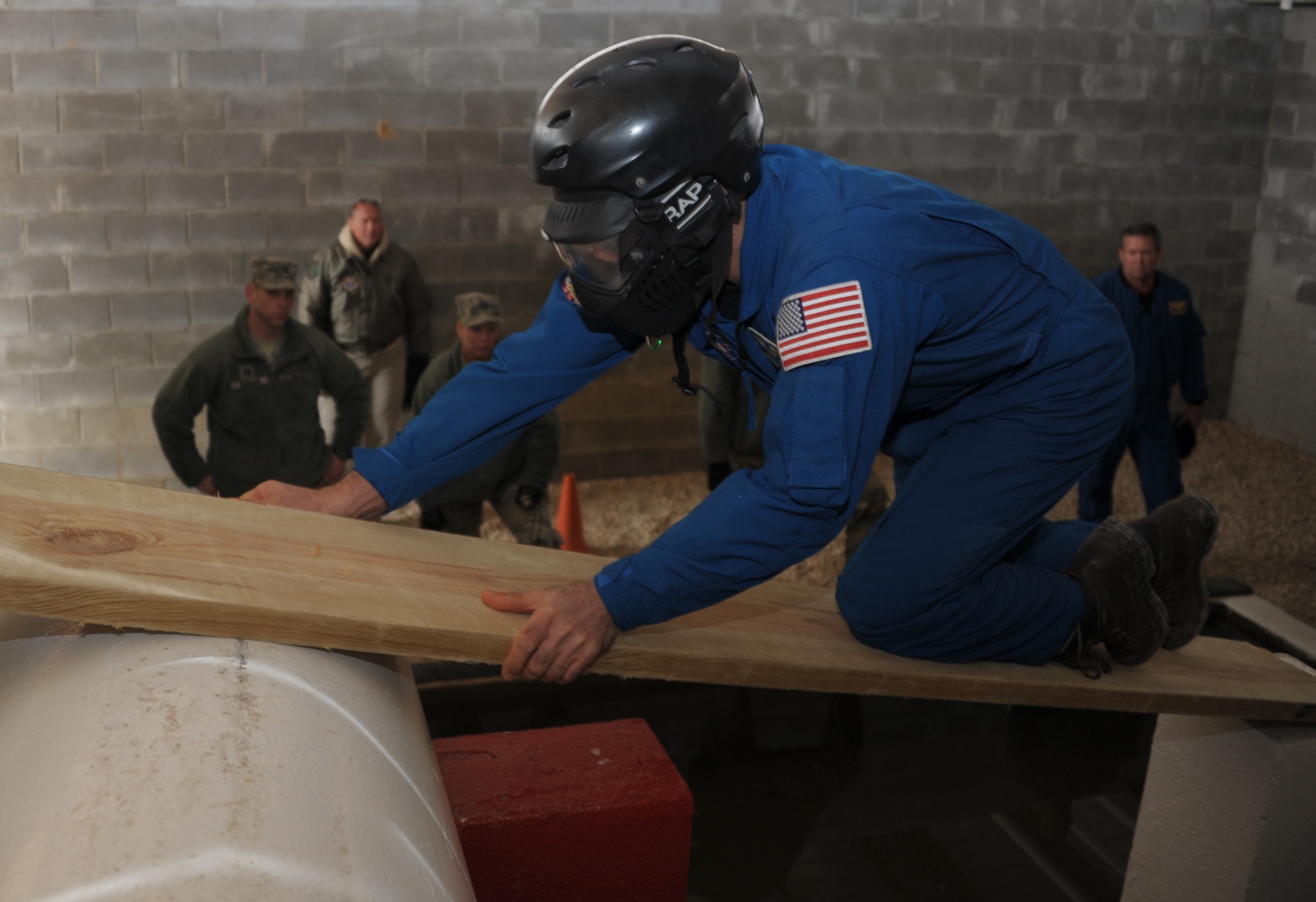 Mark Vande-hei, an astronaut from the NASA Johnson Space Center in Houston , uses a wooden board to progress over water during an obstacle at the Project X leadership reaction course on Maxwell Air Force Base, March 4th.  In addition to training in many NASA and international facilities, the group of six American and international astronauts participated in the LRC to hone their communication and teamwork skills, with different scenarios and ways of meeting core leadership training requirements. (U.S. Air Force Photo by Staff Sgt. Gregory Brook)