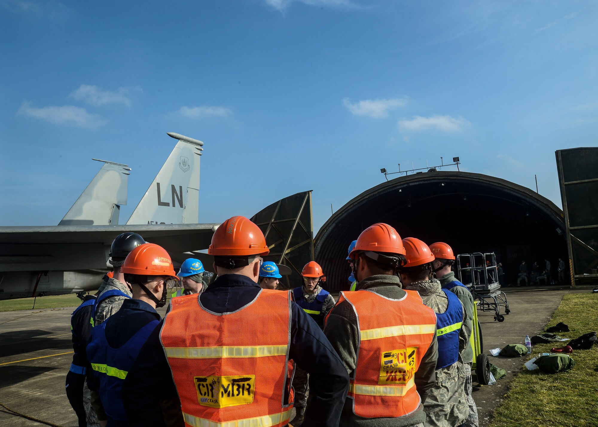 Airmen of the 48th Equipment Maintenance Squadron and the 100th Aircraft Maintenance Squadron from Royal Air Force Mildenhall are briefed during Crash Damaged Disabled Aircraft Recovery training exercise on the flightline at RAF Lakenheath, England, March 8, 2014. The training exercise was an annual joint event between RAFs Mildenhall and Lakenheath which helped familiarize and requalify Airmen on aircraft lifting procedures. (U.S. Air Force photo by Airman 1st Class Nigel Sandridge/Released)