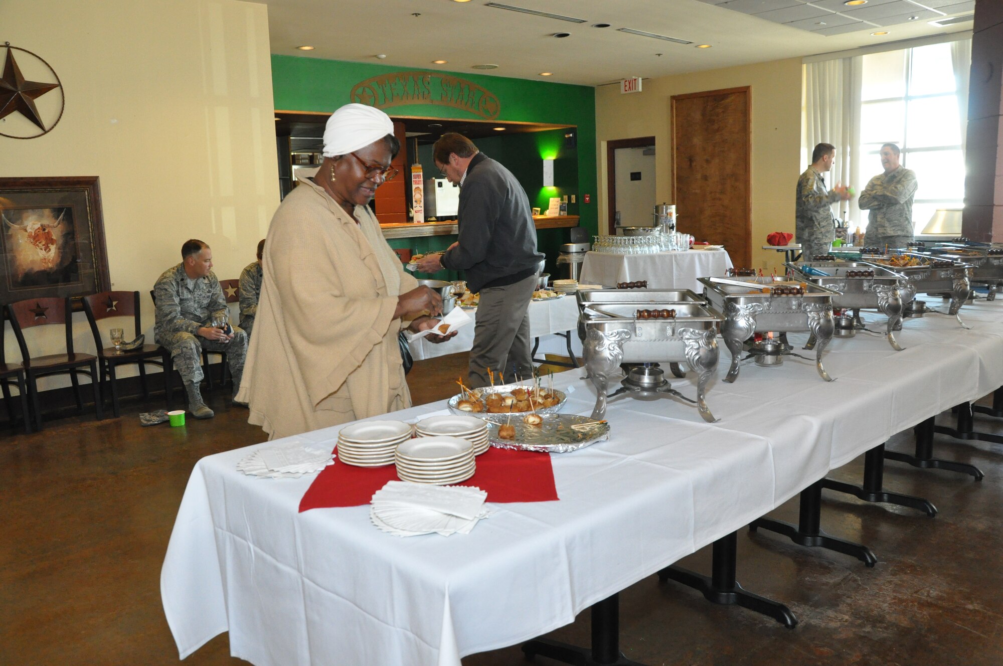 GOODFELLOW AIR FORCE BASE, Texas – Lorraine Smith, 17th Logistic Readiness Squadron customer service representative, taste tests the newest entrees and sides during the Gryphon’s Deli opening March 5. Air Force Club members were invited to participate in the opening of the deli. (U.S. Air Force photo/ Airman 1st Class Breonna Veal)