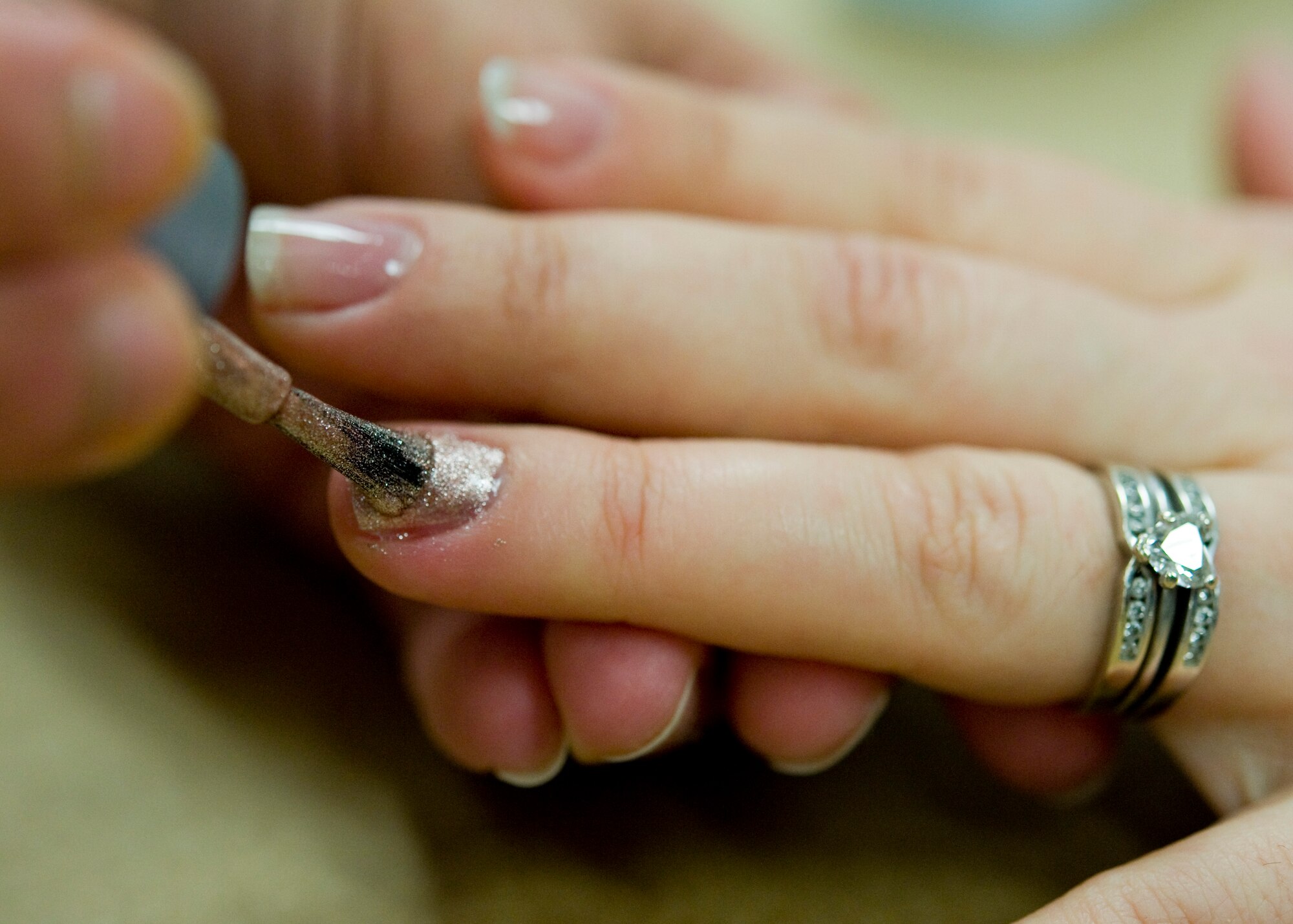 Lorna Vivoni, wife of Maj. William Vivoni, 436th Comptroller Squadron commander, paints the nails of Jennie Goede, wife of Tech. Sgt. Willaim Goede, 736th Aircraft Maintenance Squadron flying crew chief, at a spa day for the spouses of deployed Team Dover Airmen March 7, 2014, at Chapel Two on Dover Air Force Base, Del. The spa day event was put on in conjunction with the Airman and Family Readiness Center. (U.S. Air Force photo/Airman 1st Class Zachary Cacicia)