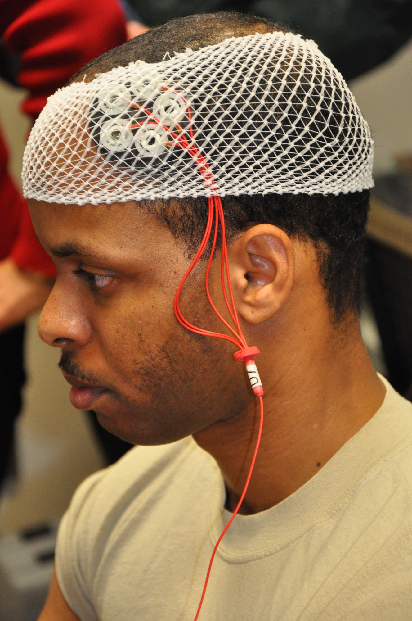 Brain stimulation study volunteer Staff Sgt. William Raydon receives a mild electric stimulation to his brain as part of a study being conducted by Air Force Research Laboratory's 711 Human Performance Wing.  The application of a mild, electric current to particular areas of the brain produces significant improvements in visual targeting and attention span, remediates the effect of fatigue on skills like these, and improves energy levels and mood in the volunteer study participants, all of whom are active-duty Airmen.
