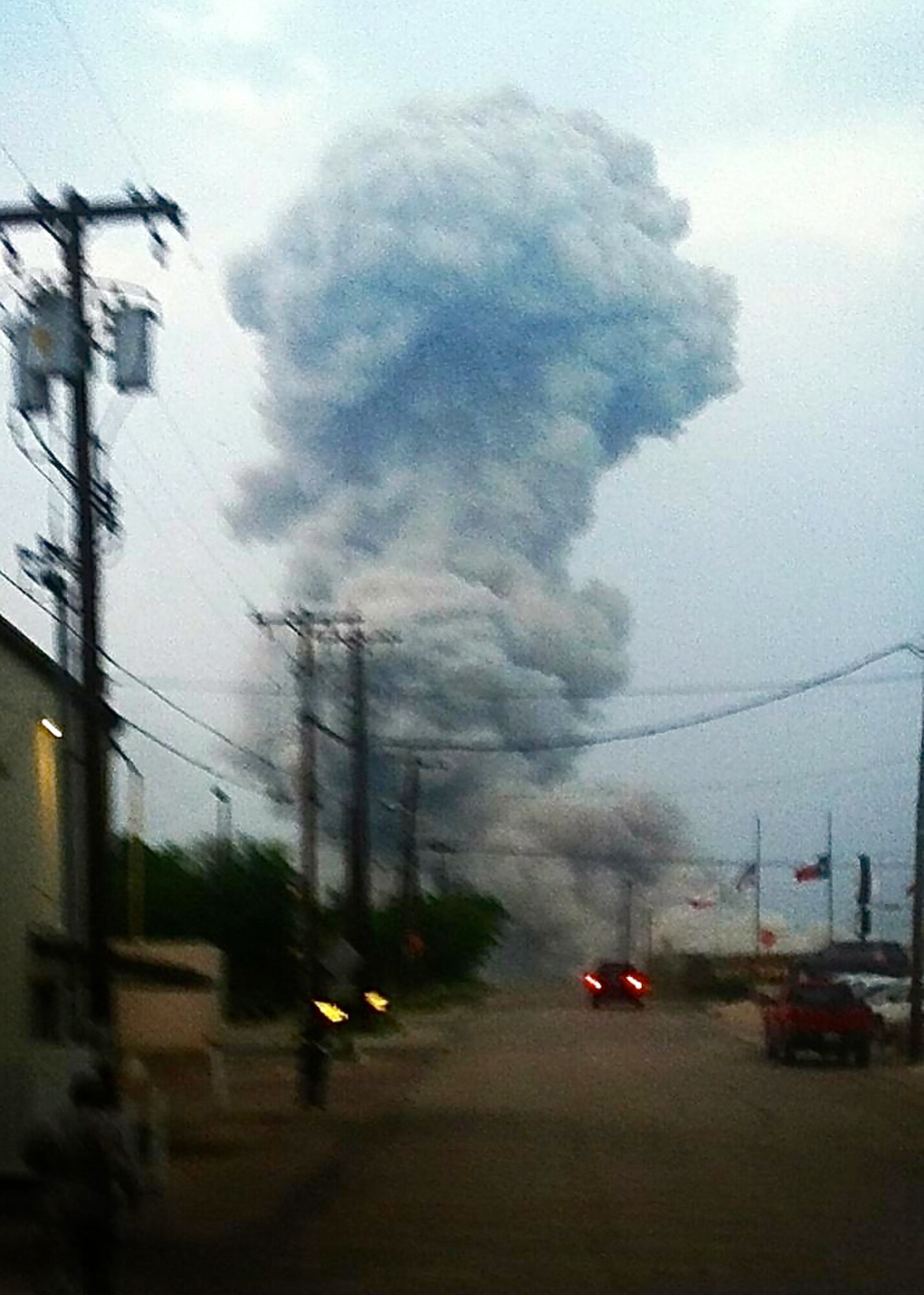 (Then) Cadet 1st Lt. Alison Nordlander snapped a photo of the mushroom cloud rising when a fertilizer plant in West, Texas, exploded April 17, 2013.  Norlander and two other cadets disregarded their personal safety to provide life-saving medical care during the explosion that claimed 15 lives and injured hundreds.  Nordlander, now a commissioned 2nd lietuenant with the 96th Medical Group, and her fellow cadets were recently honored in this year’s Air Force Portraits in Courage series which highlights the extraordinary acts of Airmen, who put their lives on the line to save others during dangerous situations. . (Courtesy photo)