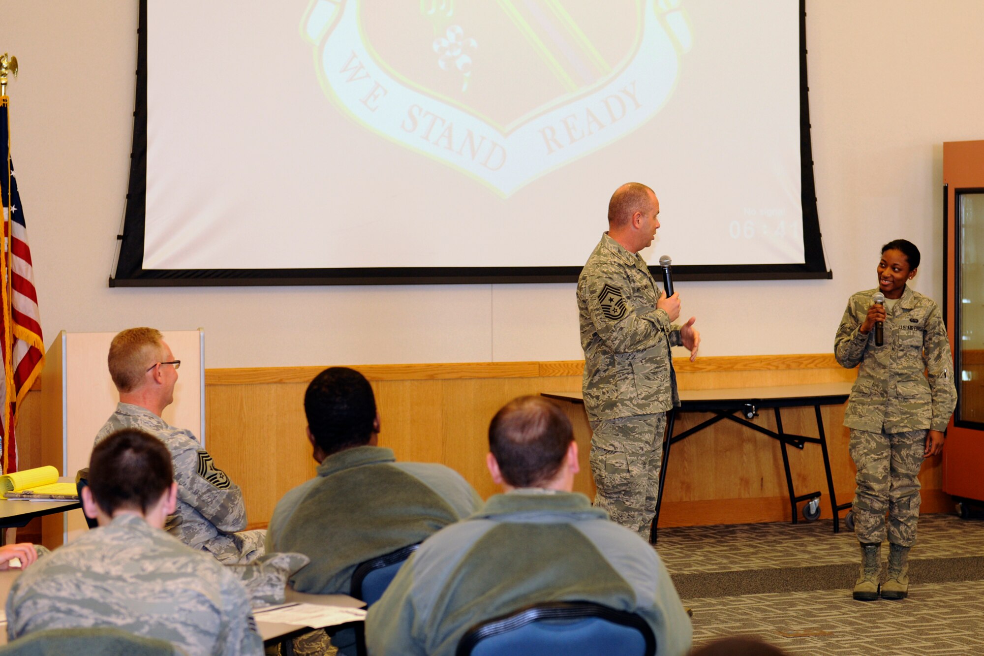 140309-Z-EZ686-015 -- Chief Master Sgt. James Hotaling, command chief of the Air National Guard, talks with Airman 1st Class Stephanie Young, a member of the 127th Operations Support Squadron, at Selfridge Air National Guard Base, Mich., during a town hall meeting at the base, March 8, 2014. Hotaling quizzed the younger Airman on her experiences in Basic Military Training, noting similarities and differences in the training now compared to the BMT experienced by some older members of the Air National Guard. Hotaling said Airmen should always remember the pride they felt upon completing BMT and use that pride to motivate them to be the best possible Airmen they can be. (Air National Guard photo by MSgt. David Kujawa / Released)