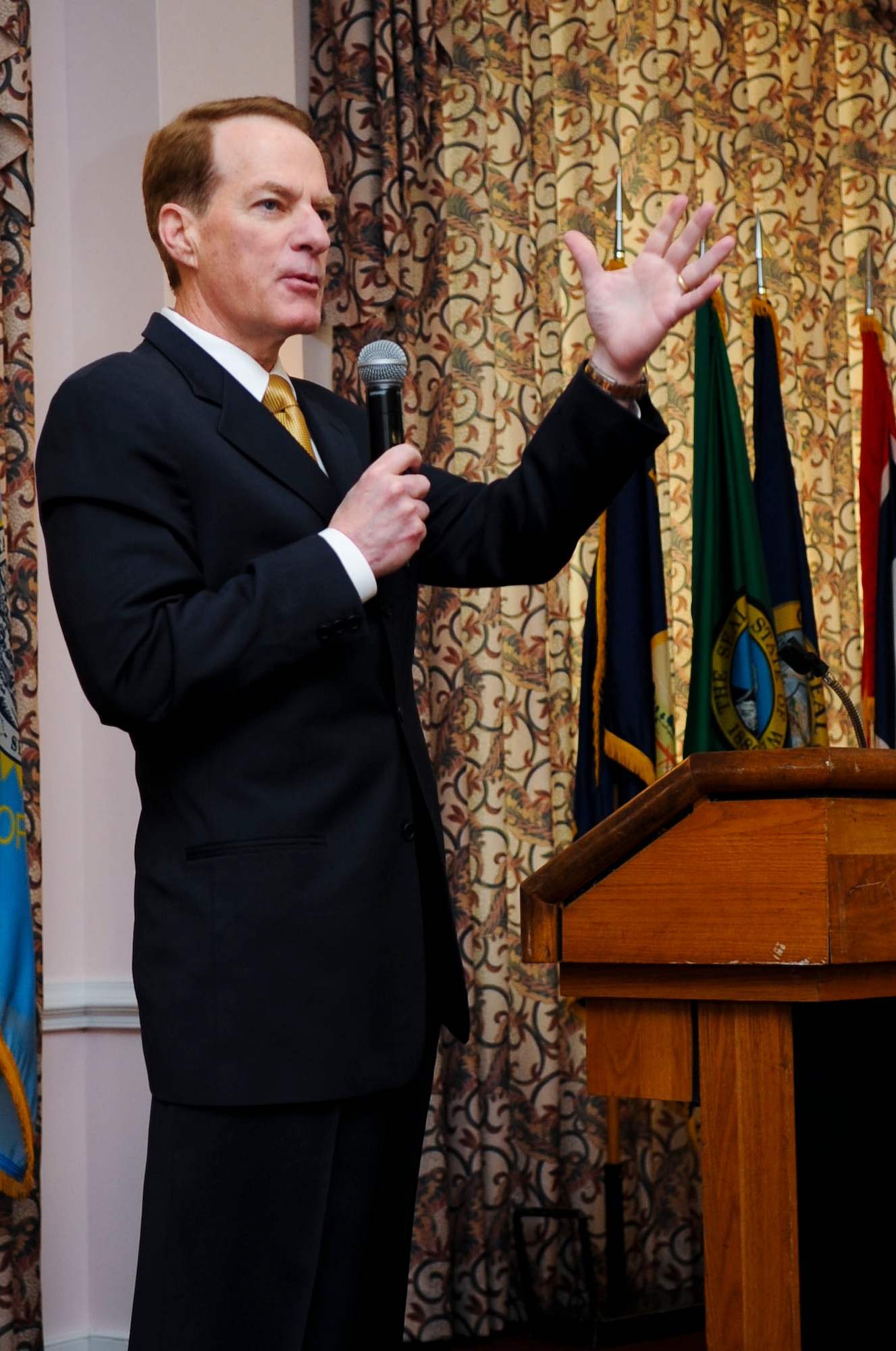 Retired U.S. Army Maj. Gen. Bradley May discusses the importance of faith during the 2014 National Prayer Breakfast at Fort Eustis, Va., March 6, 2014.  May referenced the story of a Soldier who overcame his disabilities and the positive benefits of relying on his faith. (U.S. Air Force photo by Senior Airman Austin Harvill/Released) (Photo cropped, color balanced, and contrast adjusted to enhance image)