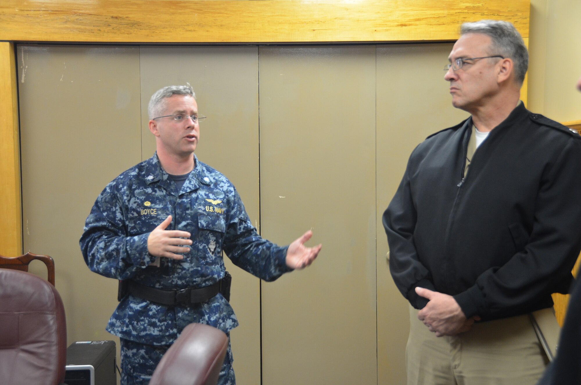 Commander Patrick Boyce, Naval Consolidated Brig Charleston commanding officer, briefs Rear Adm. Rick Williamson, Commander, Navy Region Southeast, on Brig security before taking the admiral on a tour of the facility, March 11, 2014, at Joint Base Charleston – Weapons Station, S.C. (U.S. Air Force photo/Eric Sesit)