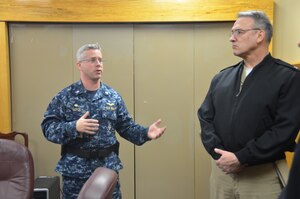 Commander Patrick Boyce, Naval Consolidated Brig Charleston commanding officer, briefs Rear Adm. Rick Williamson, Commander, Navy Region Southeast, on Brig security before taking the admiral on a tour of the facility, March 11, 2014, at Joint Base Charleston – Weapons Station, S.C. (U.S. Air Force photo/Eric Sesit)