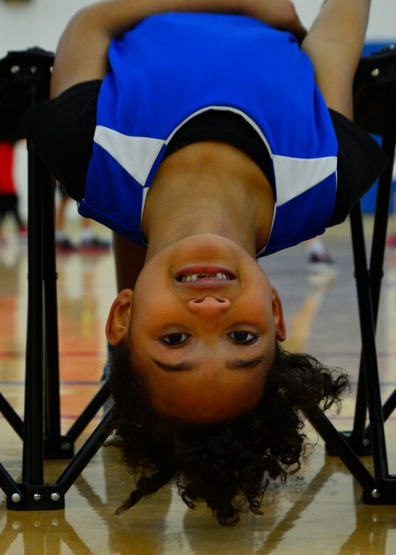 Kennedy Cordle, daughter of Staff Sgt. Brandon Cordle, 436th Civil Engineer Squadron power production craftsman, lays back on a bench during a youth basketball league game March 1, 2014, at the Youth Center on Dover Air Force Base, Del. Kennedy is involved in multiple youth league sports including basketball and soccer and is a member of the Chesapeake Bay Girl Scout Troop 1110. (U.S. Air Force photo/Airman 1st Class William Johnson)
