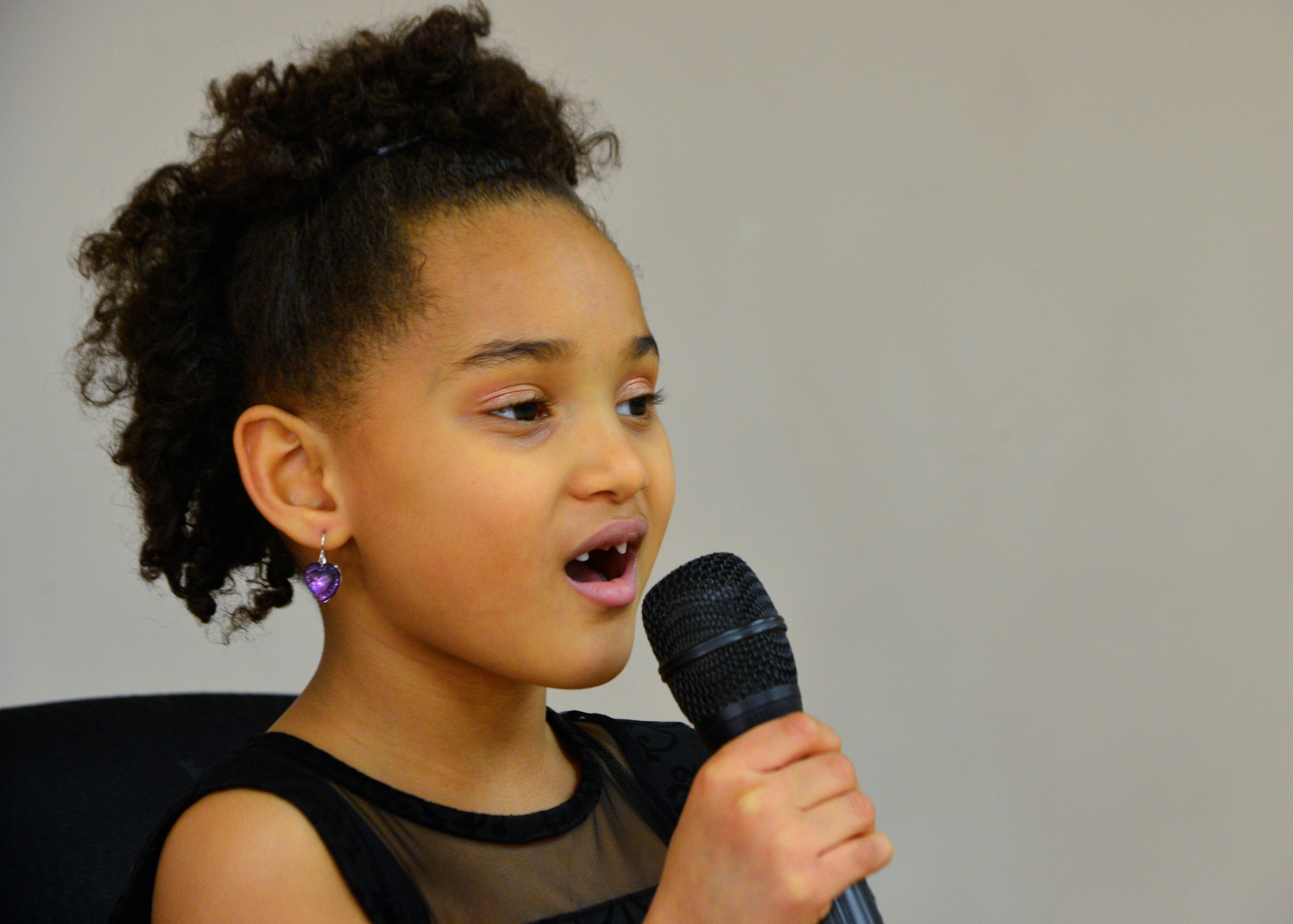 Kennedy Cordle, daughter of Staff Sgt. Brandon Cordle, 436th Civil Engineer Squadron power production craftsman, performs her singing routine March 1, 2014, at the Youth Center on Dover Air Force Base, Del. Kennedy sang “Greatest Love of All” by Whitney Houston to win first place in the Air Force “U Got Talent” competition. (U.S. Air Force photo/Airman 1st Class William Johnson)