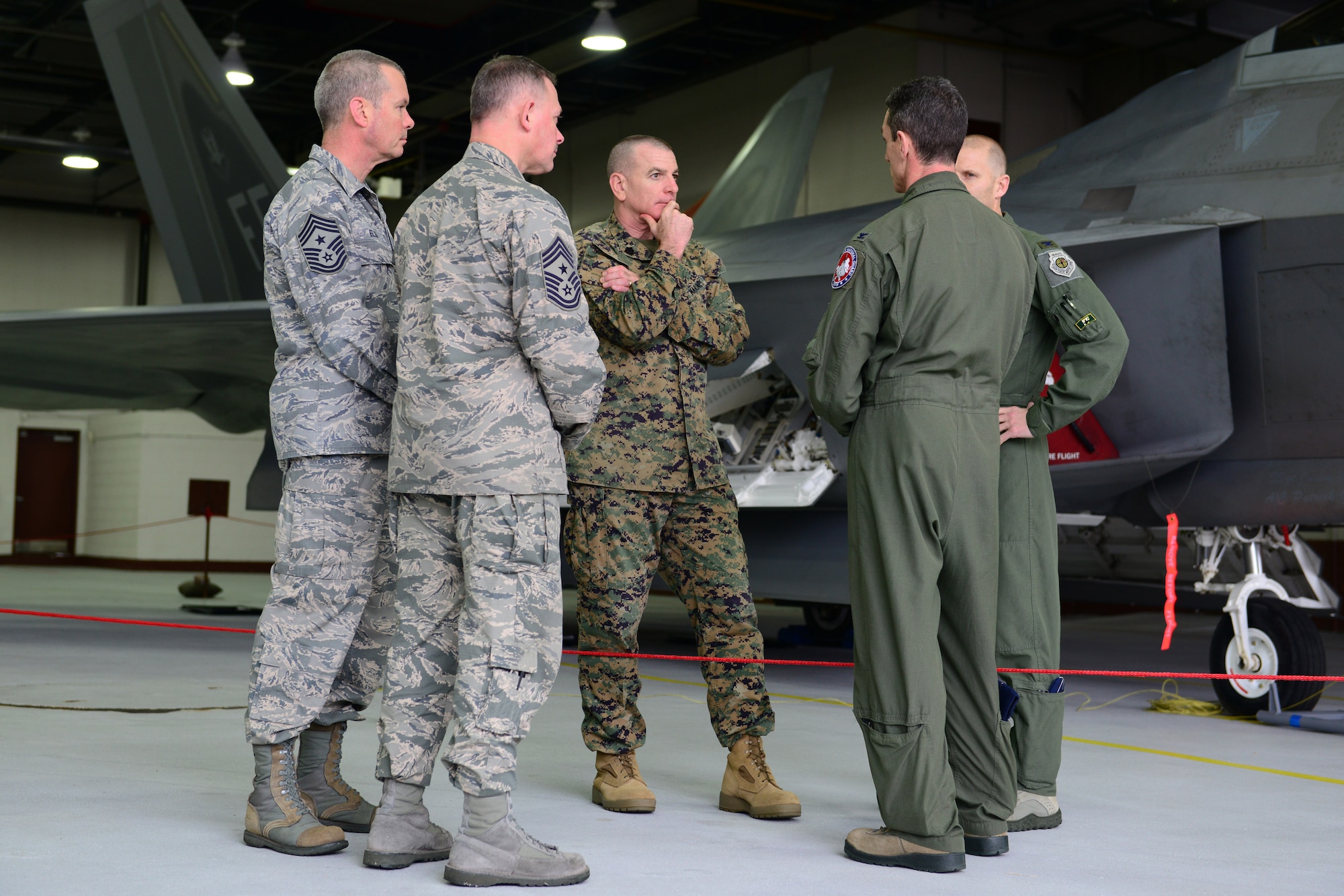 U.S. Marine Corps Sgt. Maj. Bryan Battaglia, Senior Enlisted Advisor to the Chairman of the Joint Chiefs of Staff, speaks with 1st and 192nd Fighter Wings leadership at Langley Air Force Base, Va., March 7, 2014. Battaglia was briefed on the F-22 Raptor’s mission overview and proficiency. (U.S. Air Force photo by Airman 1st Class Kimberly Nagle/Released)(Photo cropped to emphasize the subject) 