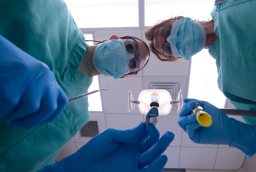 U.S. Air Force Capt. (Dr.) Jamie Smith, 23d Aerospace Medicine Squadron general dentist, and Shelley Norton, 23d AMDS certified dental assistant, mimic a dental cleaning at Moody Air Force Base, Ga., March 6, 2014. The dental clinic recently celebrated Dental Assistants Recognition Week, generally held the first week of March. (U.S. Air Force photo by Senior Airman Tiffany M. Grigg/Released) 