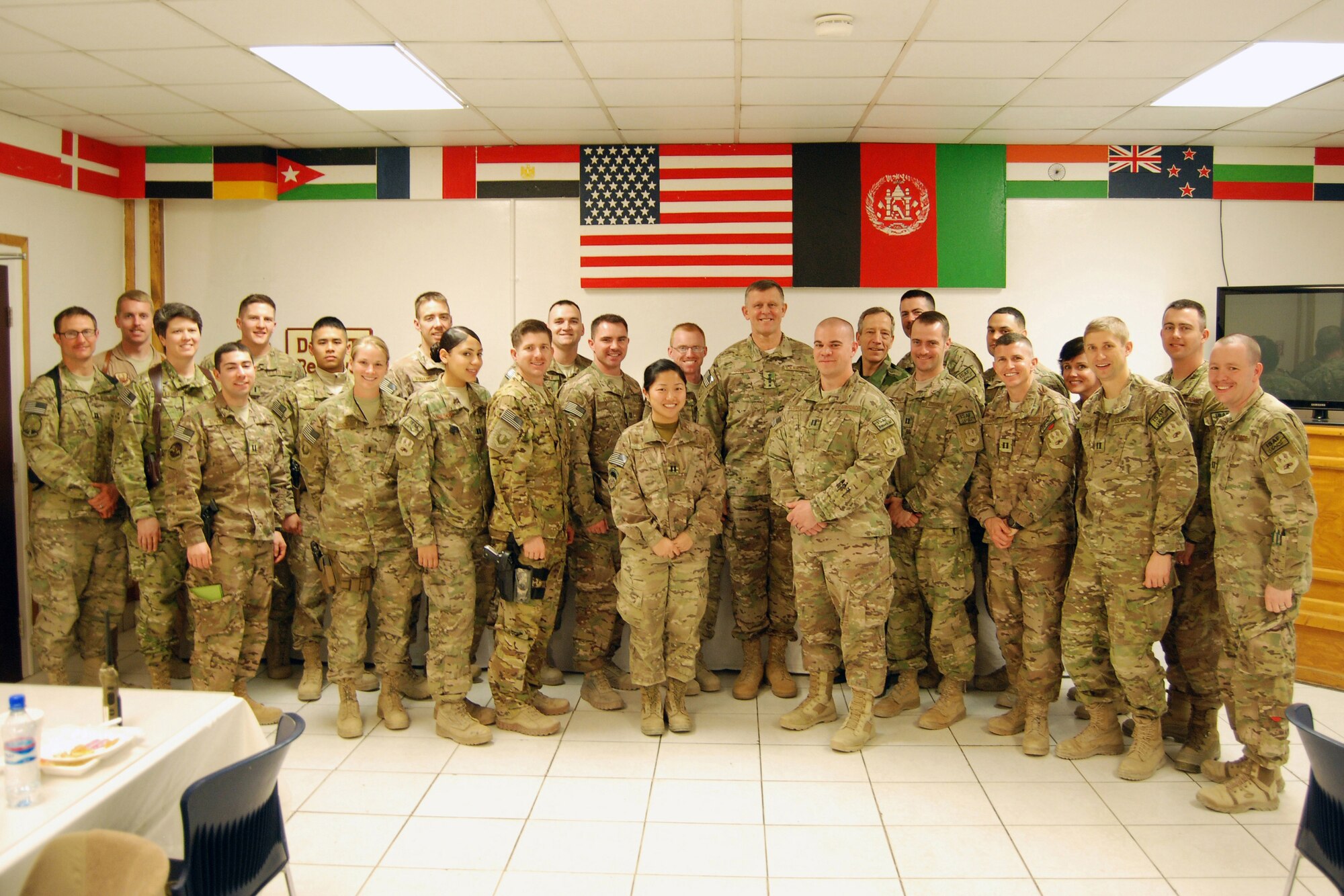 U.S. Air Force Gen. Frank Gorenc, NATO Allied Air Command and U.S. Air Forces in Europe- Air Forces Africa commander, and French Lt. Gen. Dominique de Longvilliers, NATO Allied Air Command deputy commander, pose for a photo with company grade officers during a visit to Bagram Airfield, March 10, 2014. During the lunch, Gorenc answered questions and discussed leadership topics. (U.S. Air Force photo by Brig Gen Patrick Malackowski/Released)