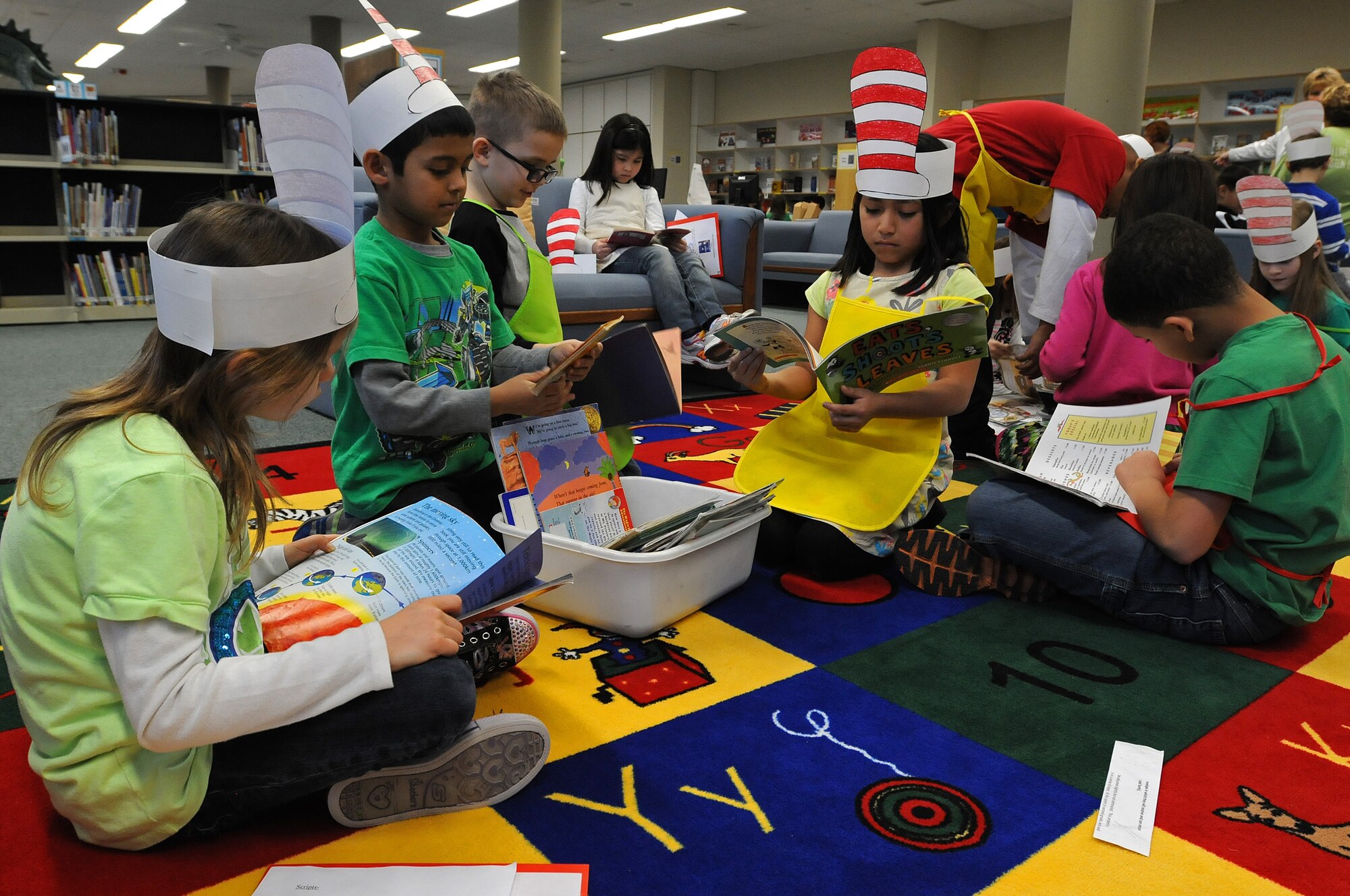 Students of Bonnie Grimes’ second grade class read during a break from serving popcorn and seating younger children at the reading café at Ramstein Elementary School during Read Across America week Mar. 3, 2014, Ramstein Air Base, Germany. Read Across America is a week-long celebration, held the week of Dr. Seuss’ birthday, to teach children the importance of reading and education in schools across America and U.S. military installations overseas. (U.S. Air Force photo/Airman 1st Class Holly Mansfield)