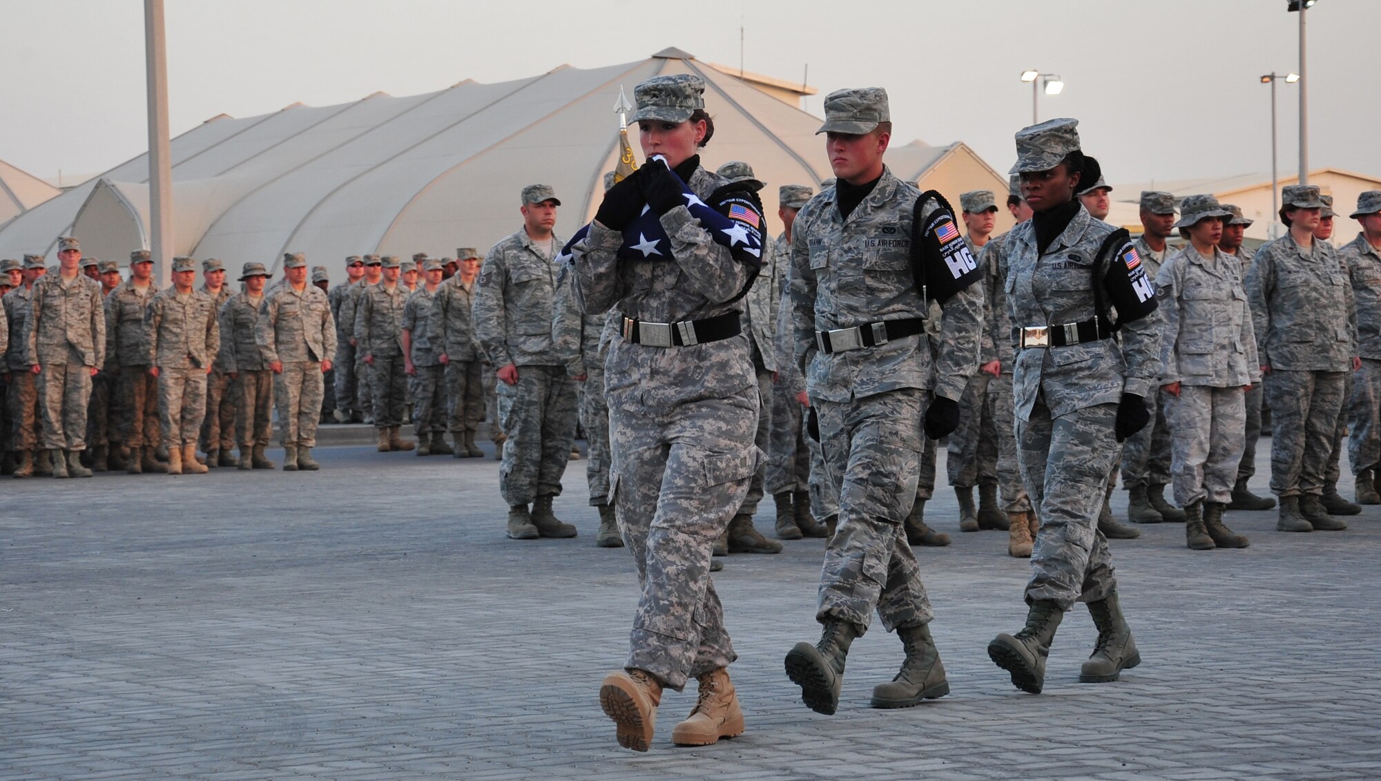 Members of the base honor guard retire the colors following a retreat ceremony at an undisclosed location in Southwest Asia, March 7, 2014. (U.S. Air Force photo by Staff Sgt. Michael Means/Released)