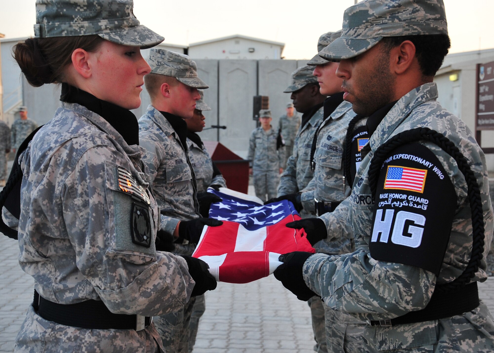 Members of the base honor guard fold the flag during a retreat ceremony at an undisclosed location in Southwest Asia, March 7, 2014. (U.S. Air Force photo by Staff Sgt. Michael Means/Released)