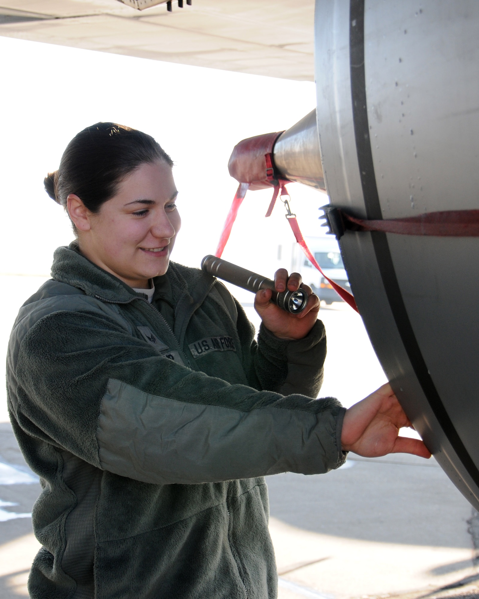 U.S. Air Force Senior Airman Jessica Tharp, 100th Aircraft Maintenance Squadron aerospace propulsion journeyman from Lancaster, Ohio, inspects the exhaust section of a KC-135 Stratotanker March 4, 2014, on RAF Mildenhall, England. When aerospace propulsion journeymen finish troubleshooting problems and have established what was wrong, they remove and replace the broken components with serviceable ones. After maintenance is complete they perform engine run tests to make sure the problem is fixed and the engine operates as it should.  (U.S. Air Force photo by Gina Randall/Released)