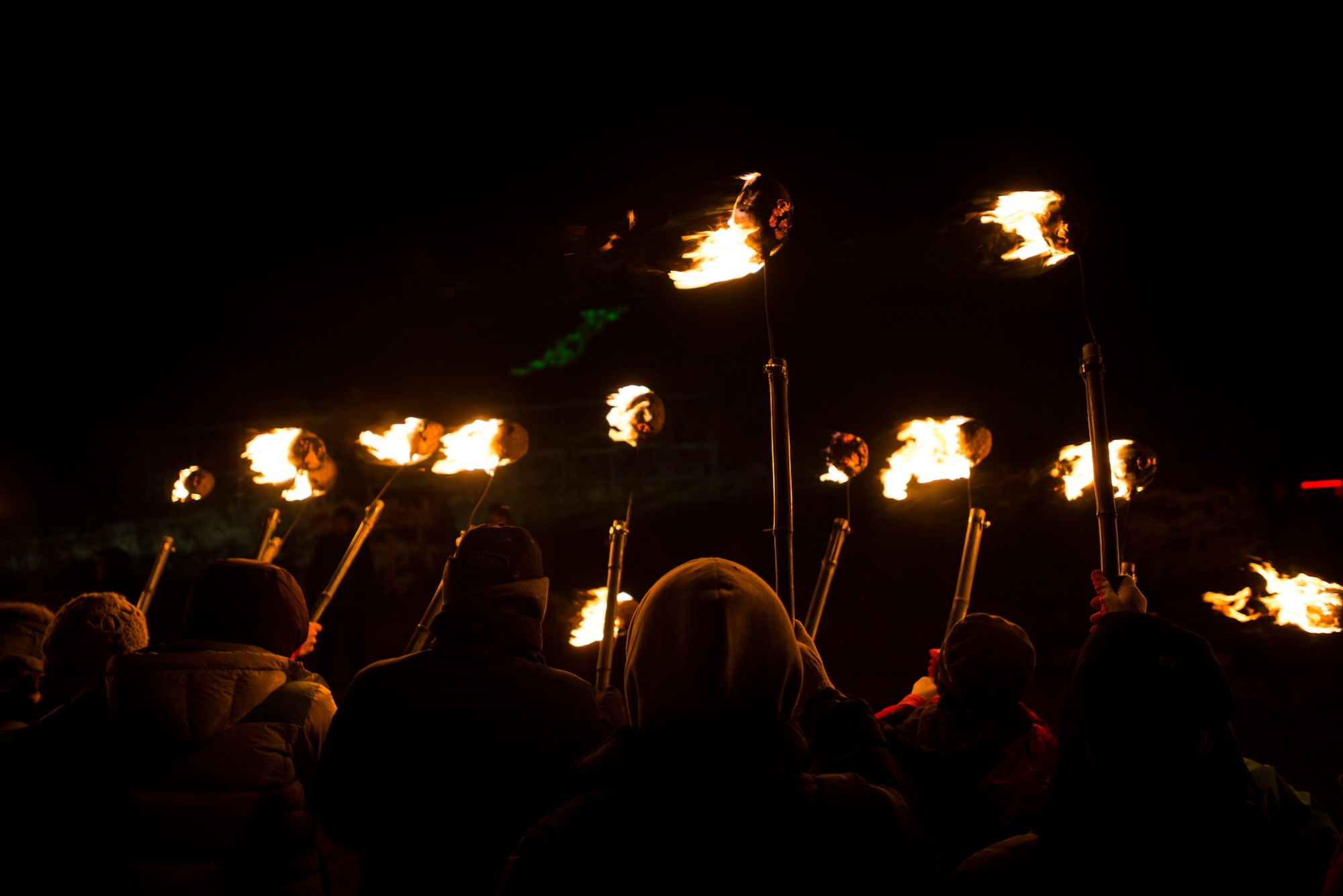 Particpants raise their torches at the Fire Festival March 9, 2014, in Jeju, Republic of Korea. The fire festival stems from the Korean practice of burning fields in order to eliminate pests that might contaminate cattle's food. (U.S. Air Force photo by Staff Sgt. Jake Barreiro)