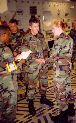 Senior Airman Corrine Price and Airman 1st Class Chris Rekrut are married in the back of a C-17 Globmaster cargo aircraft at what was then McChord Air Force Base, July 19, 2002. The Rekruts have been married for 11 years now, and Chris was promoted to Master Sergeant by means of the Stripes for Exceptional Performers program Dec. 18, 2013, while serving as the 728th Air Mobility Squadron Quality Assurance superintendent at Incirlik Air Base, Turkey. (Courtesy photo) 