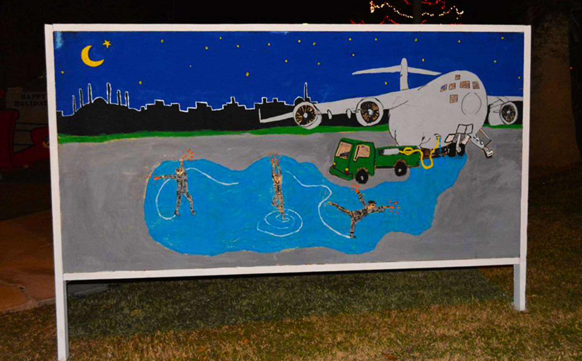 The 728th Air Mobility Squadron holiday “card” stands outside the Incirlik Consolidated Club Complex awaiting judging during the 2013 holiday season. The card was created by Master Sgt. Chris Rekrut, 727th AMS Quality Assurance superintendent, and his wife, Corrine, and won third place. (Photo by Carla Bigger)