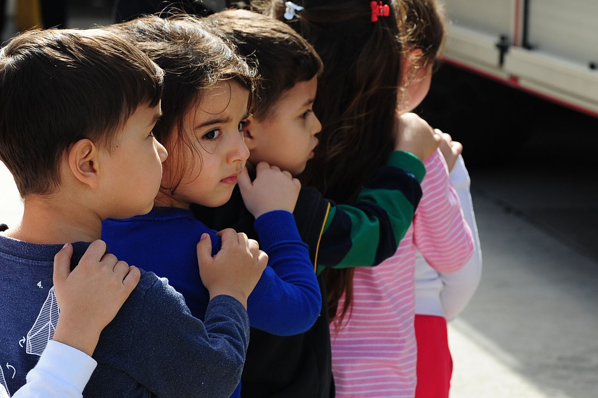 Turkish schoolchildren stand in a line and wait to be lifted inside of a fire truck March 6, 2014, Incirlik Air Base Turkey.  During their visit to the 39th Civil Engineer Squadron fire department, they caught a glimpse of what it feels like to ride in a fire truck and work inside of a fire department.(U.S. Air Force photo by Senior Airman Nicole Sikorski/Released)