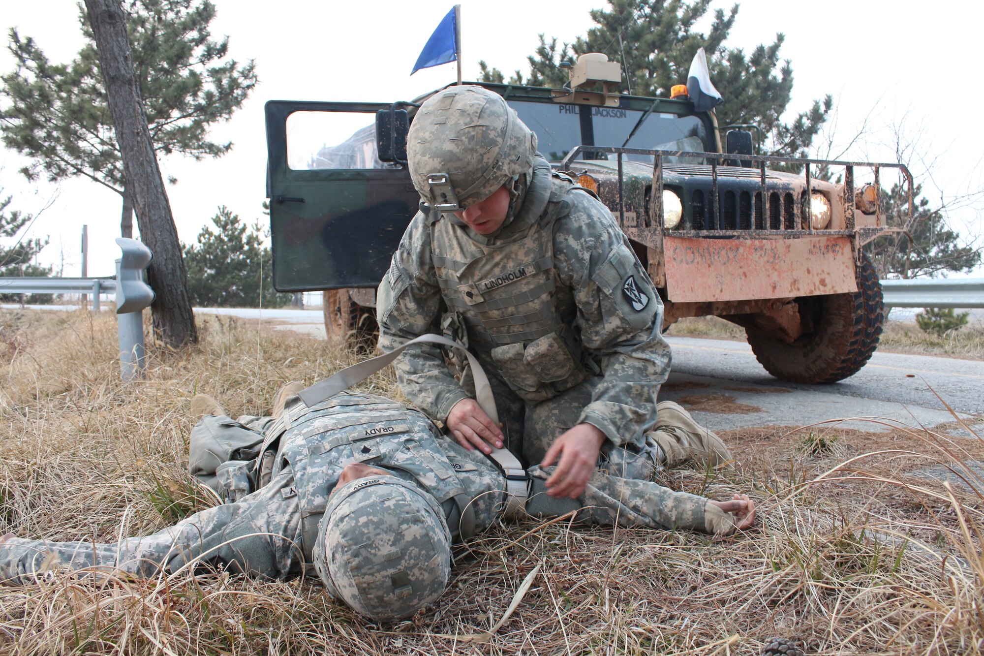 SEOSAN AIR BASE, Republic of Korea - Spc. Brandon Lindholm applies his belt as a makeshift tourniquet to a simulated casualty, Spc. Porsha Grady, both launcher crew members with Battery A, 6-52 ADA, during the Iron Resolve field training exercise at Seosan AB, Feb. 24. (Photo by Pfc. Shin, Young-Jae, 6-52 ADA Public Affairs)
