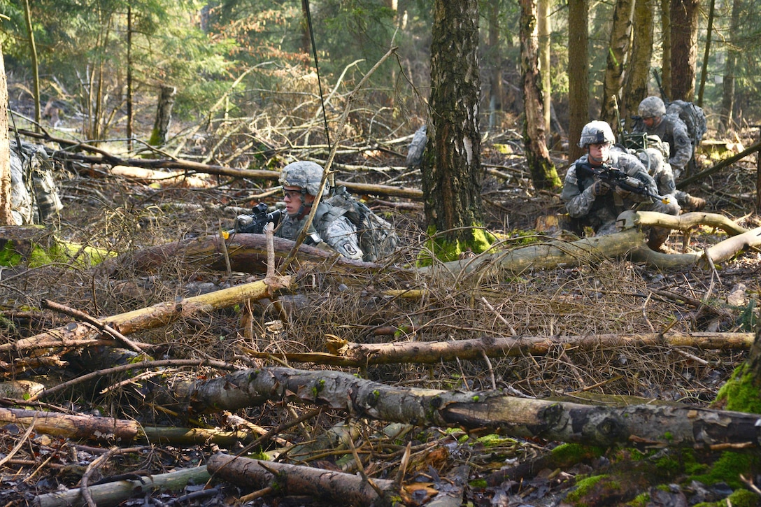 U.S. soldiers set up defensive fighting positions during squad level ...