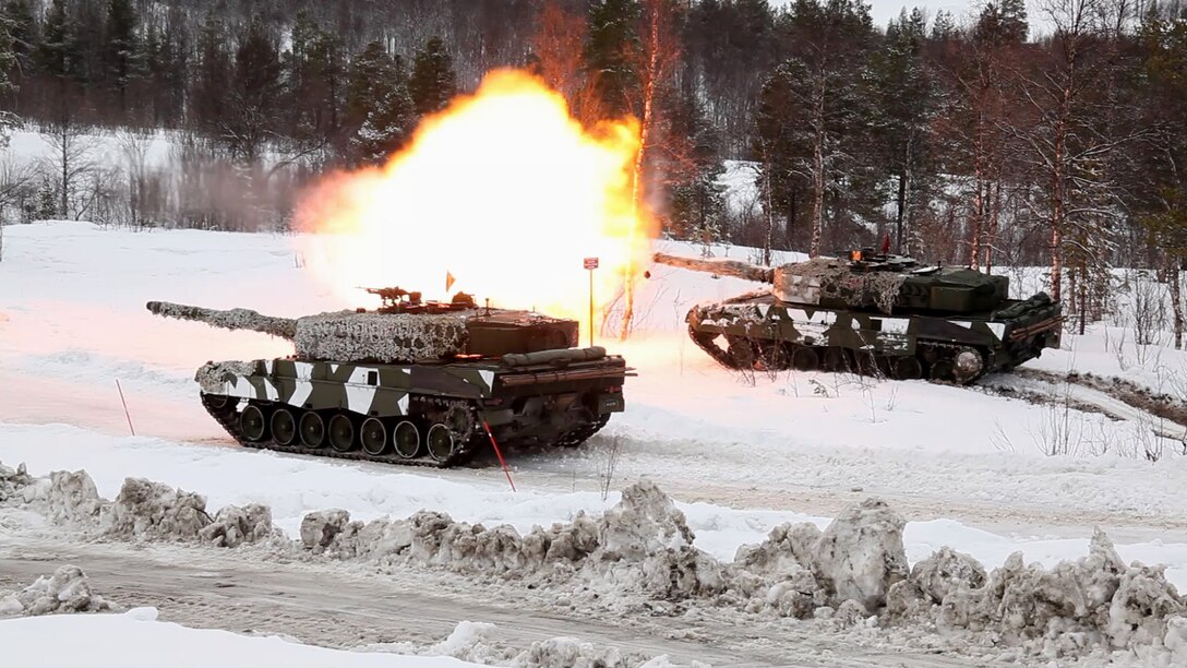 Norwegian tanks take part in a live-fire capabilities demonstration during Cold Response 14, a multinational and multilateral training exercise above the Arctic Circle that brings together more than 14,000 servicemembers from 15 different countries, to include approximately 1,200 NATO personnel, March 11. The Norwegian-led exercise involves maritime, land and air operations being conducted this month to rehearse high-intensity operations in unique winter conditions, showcasing the diplomatic relationships, strategic friendships, and commitment to global security interests of all participating nations. The majority of the servicemembers are participating from the United States, Norway, Canada, France, the Netherlands, Great Britain and Sweden. (Official Air Force Photograph by Tech Sgt. Burt Traynor)