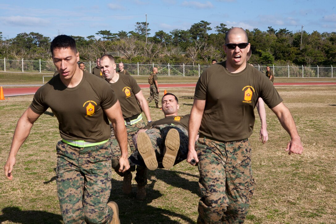 Marines with the Staff Noncommissioned Officer Academy Okinawa compete in a casualty-carry relay Jan. 29 during the Director’s Challenge Field Meet at Camp Hansen. The event tested the Marines’ ability to work as a team while they transport a “wounded” Marine from one end of the field to the other.



