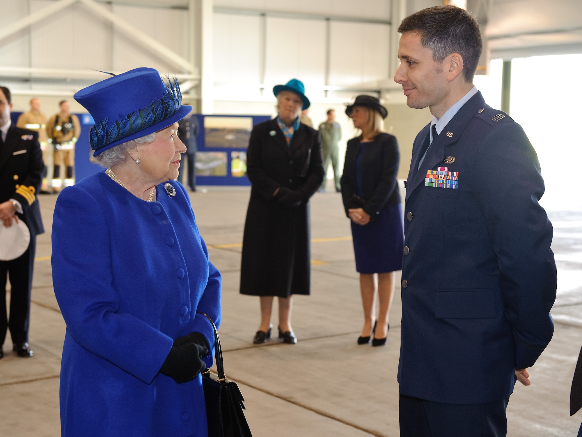 Her Majesty Queen Elizabeth II chats with Capt. Brusle Sherburne of the Air Force Intelligence, Surveillance and Reconnaissance Agency at Royal Air Force Marham, United Kingdom Feb. 3, 2014. Sherburne is the Air Force exchange officer with the Tactical Imagery-Intelligence Wing at Marham, UK. (Courtesy photo) 